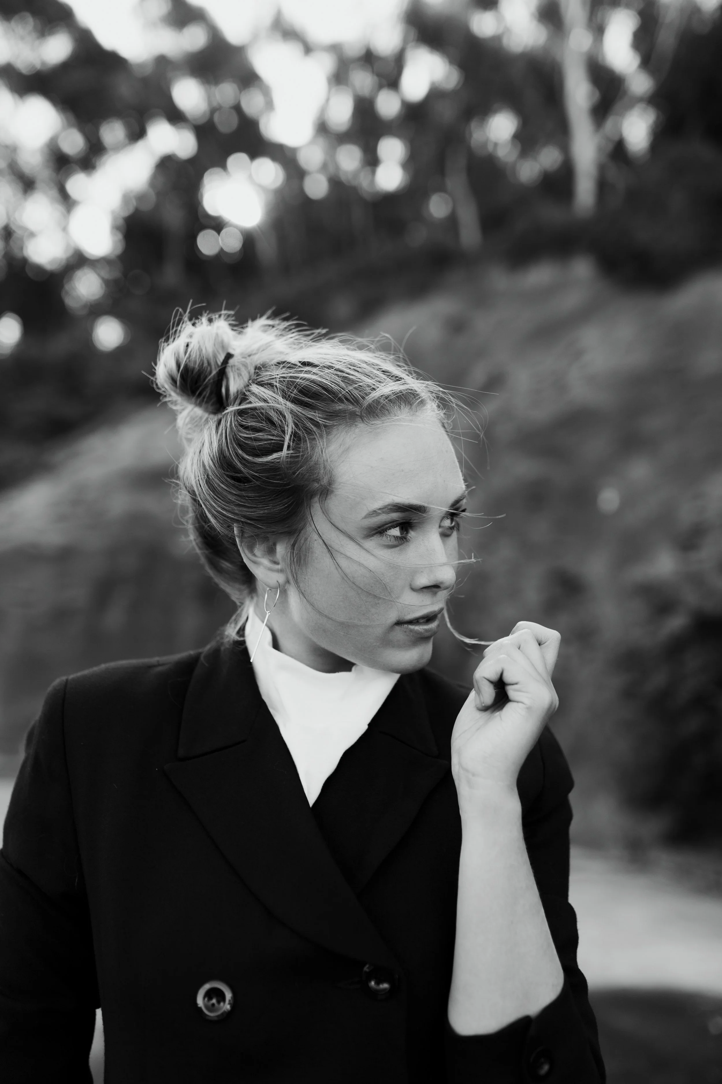 Blonde woman looks into distance for model test shoot in Tasmania.