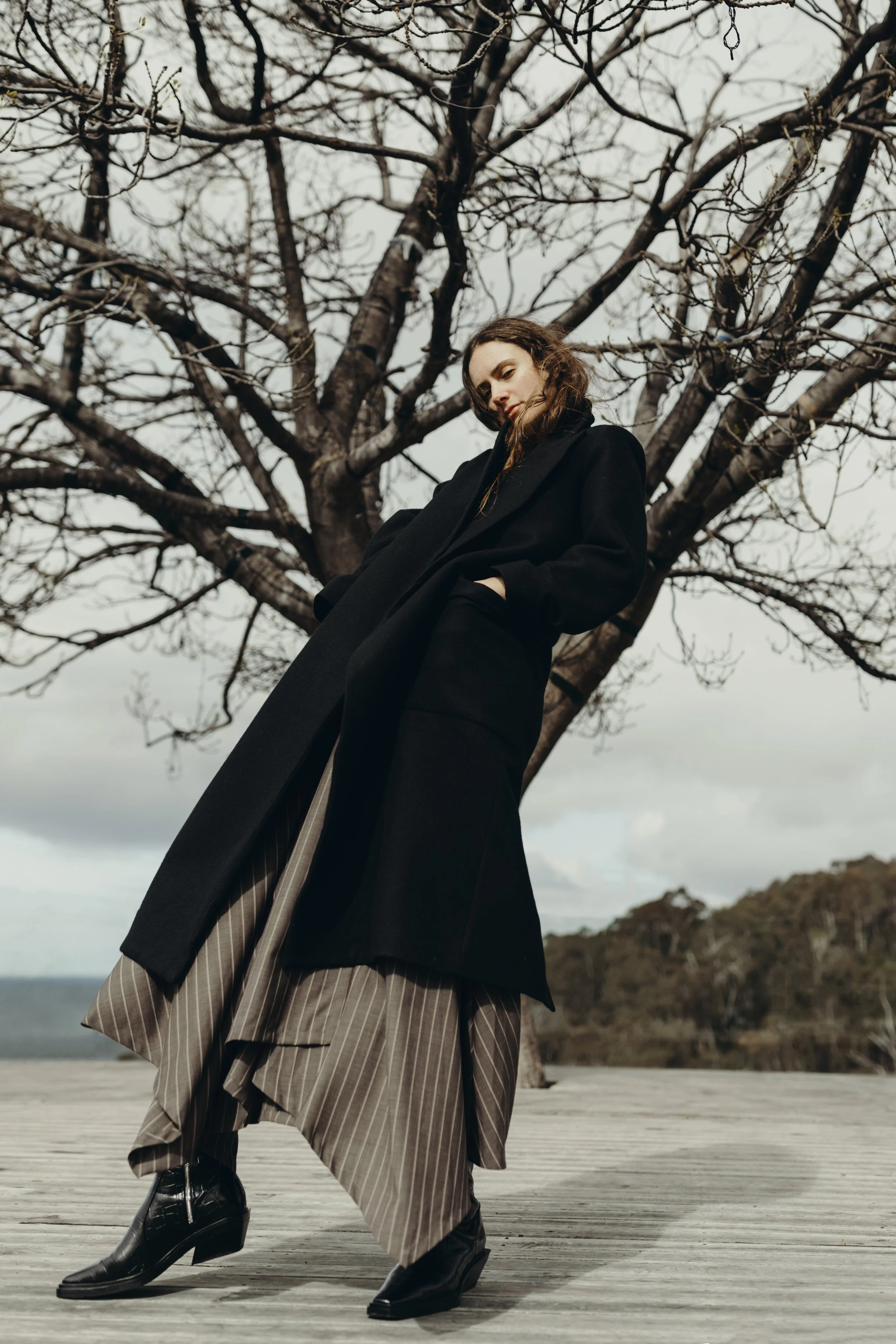 Model poses in classic coat for fashion photo shoot in Hobart, Tasmania.