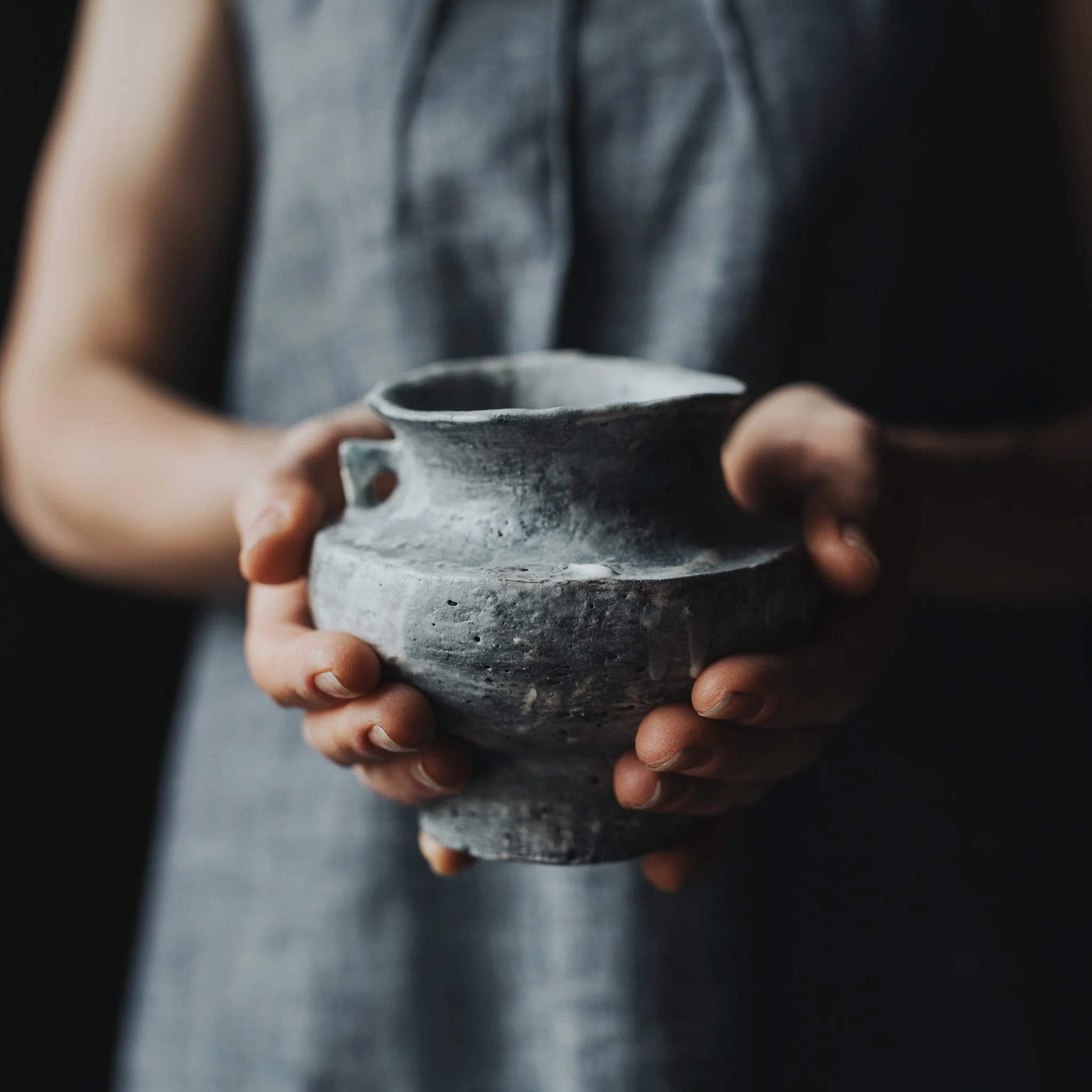 Hands hold ceramic pot for product photo shoot in Tasmania.