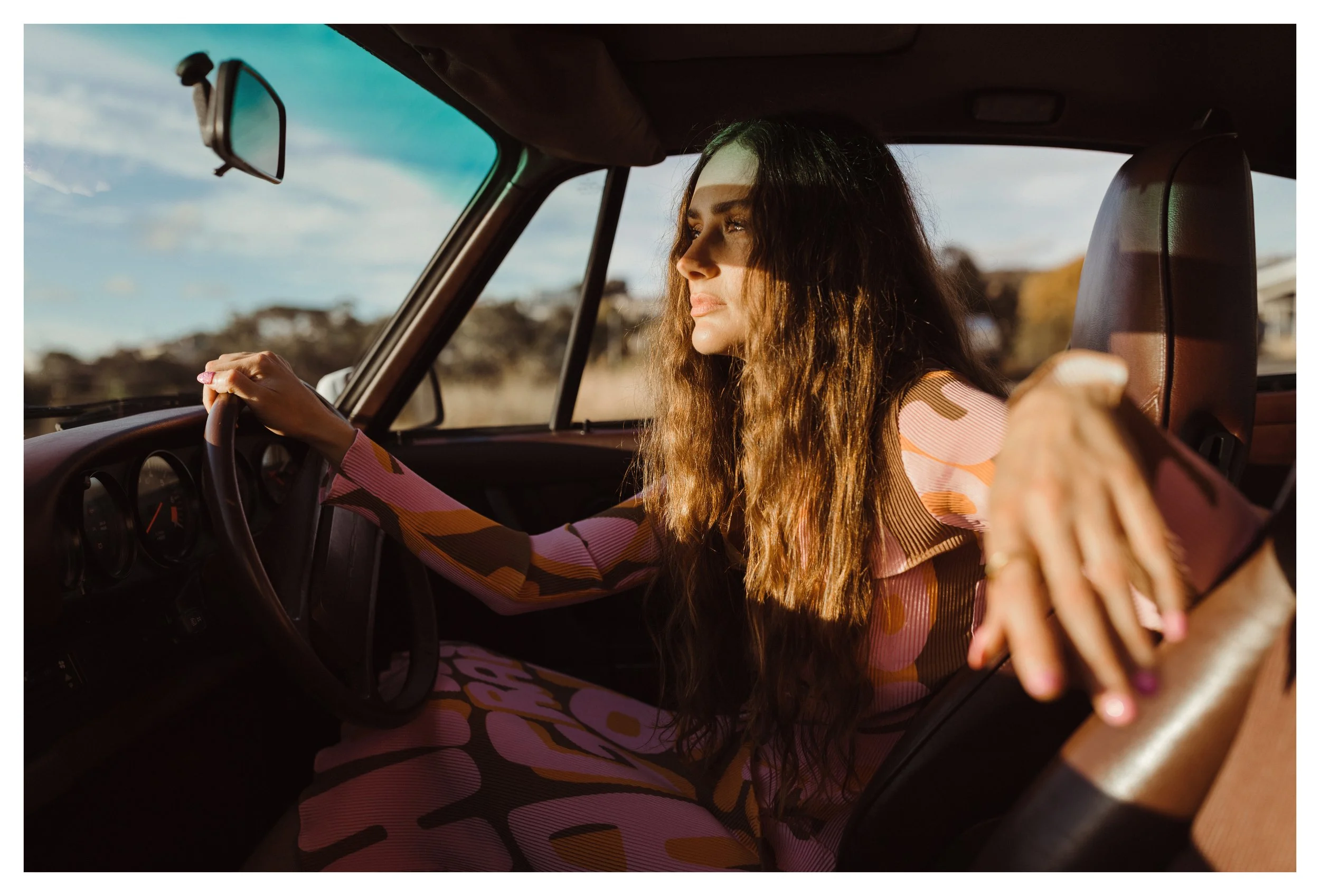 Model sits in vintage porsche for styled photo shoot in Tasmania.