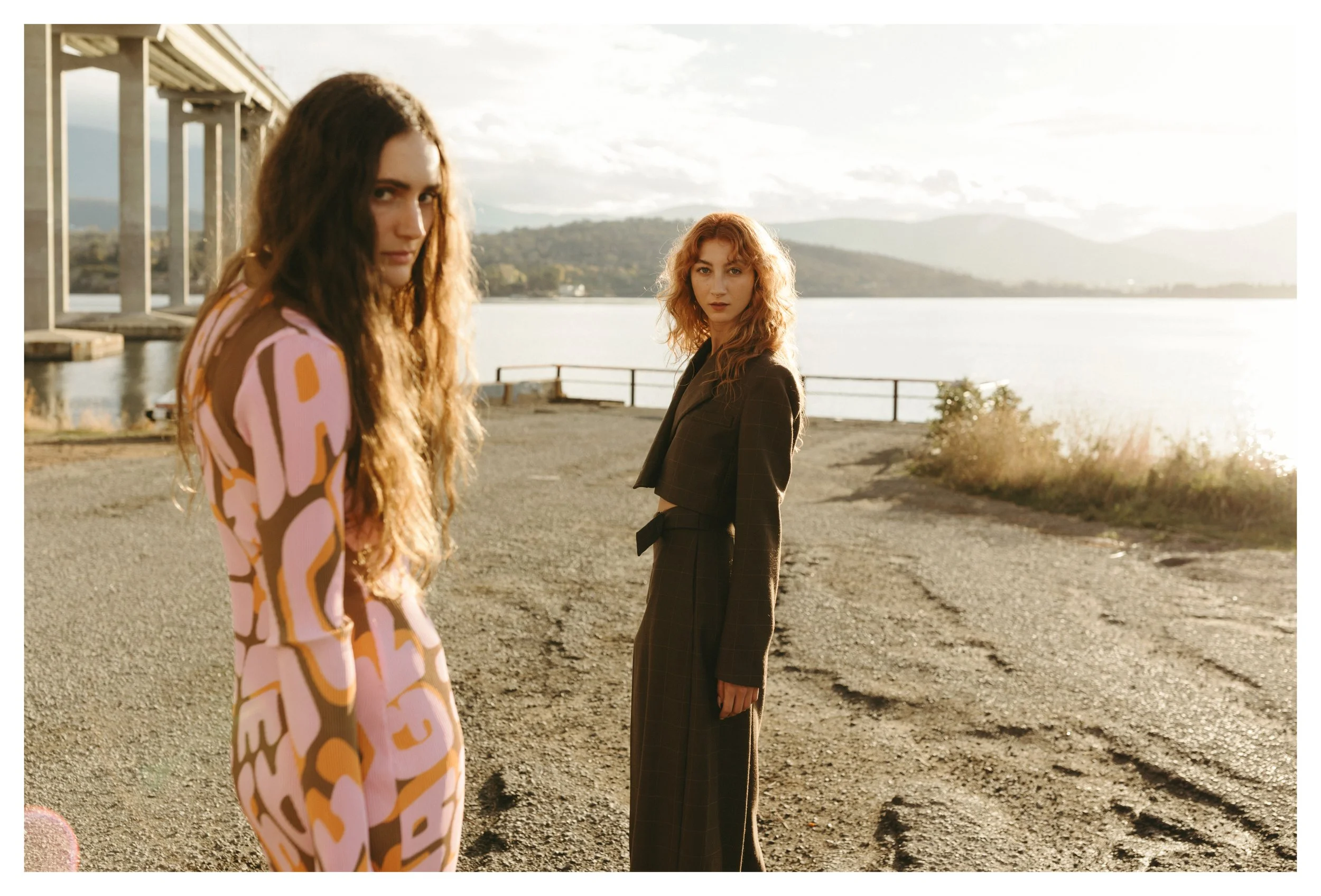 Two models look into camera for sunset photo shoot in Tasmania.