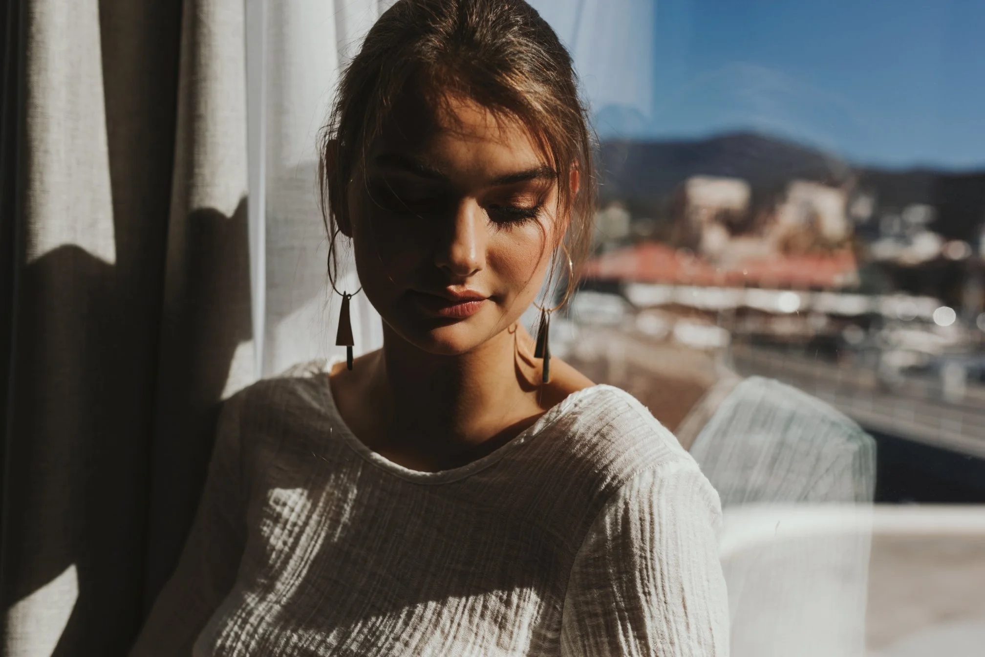 Model leans against window in photo shoot for Ally and Me.