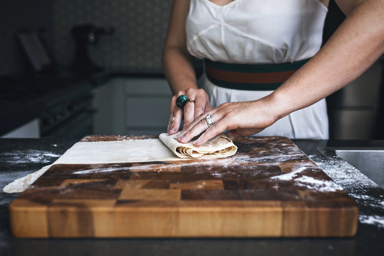 Chef folds pasta dough during branding photo shoot in Sydney, Australia.