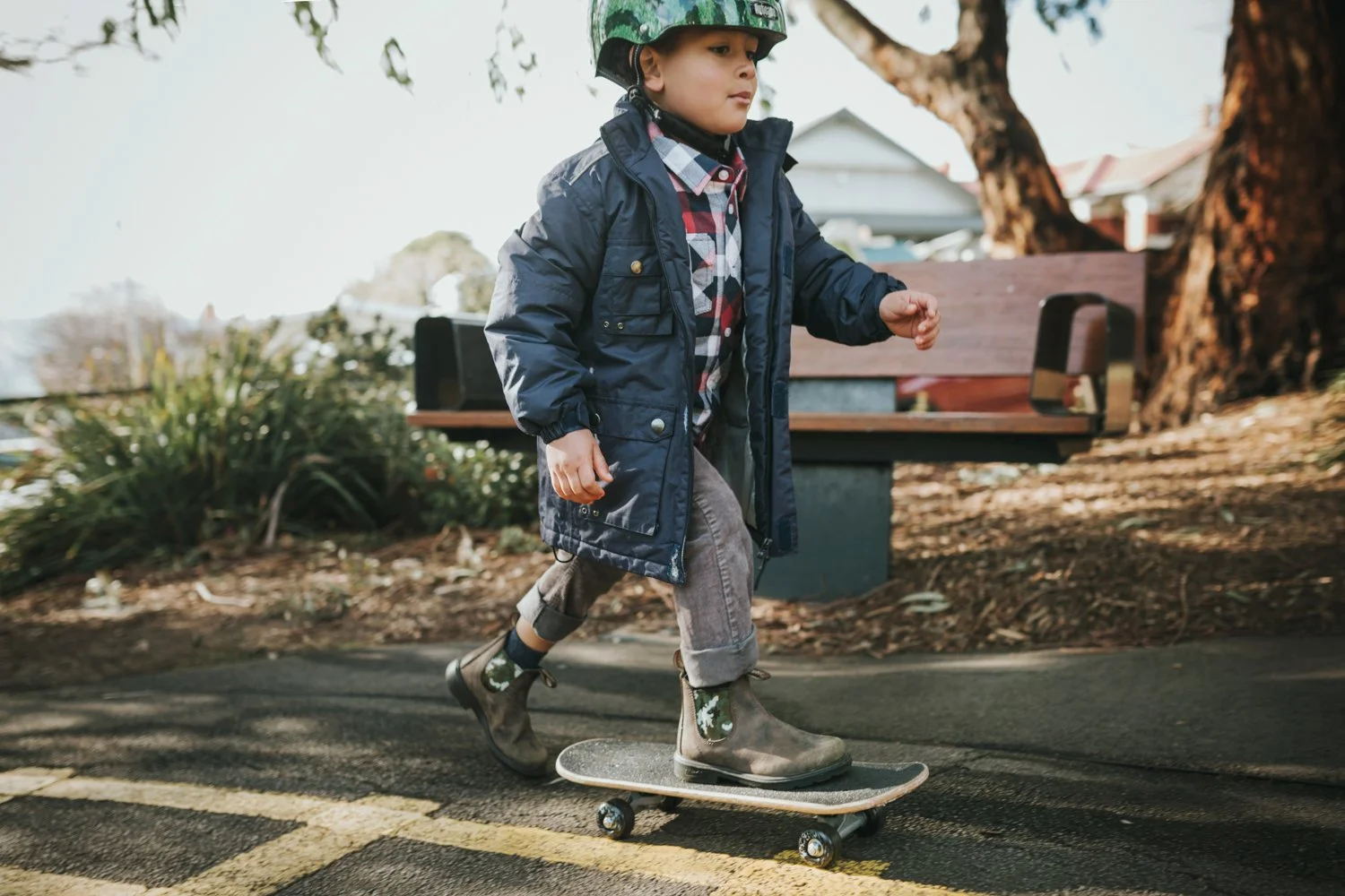 Young boy on skateboard in Hobart park.