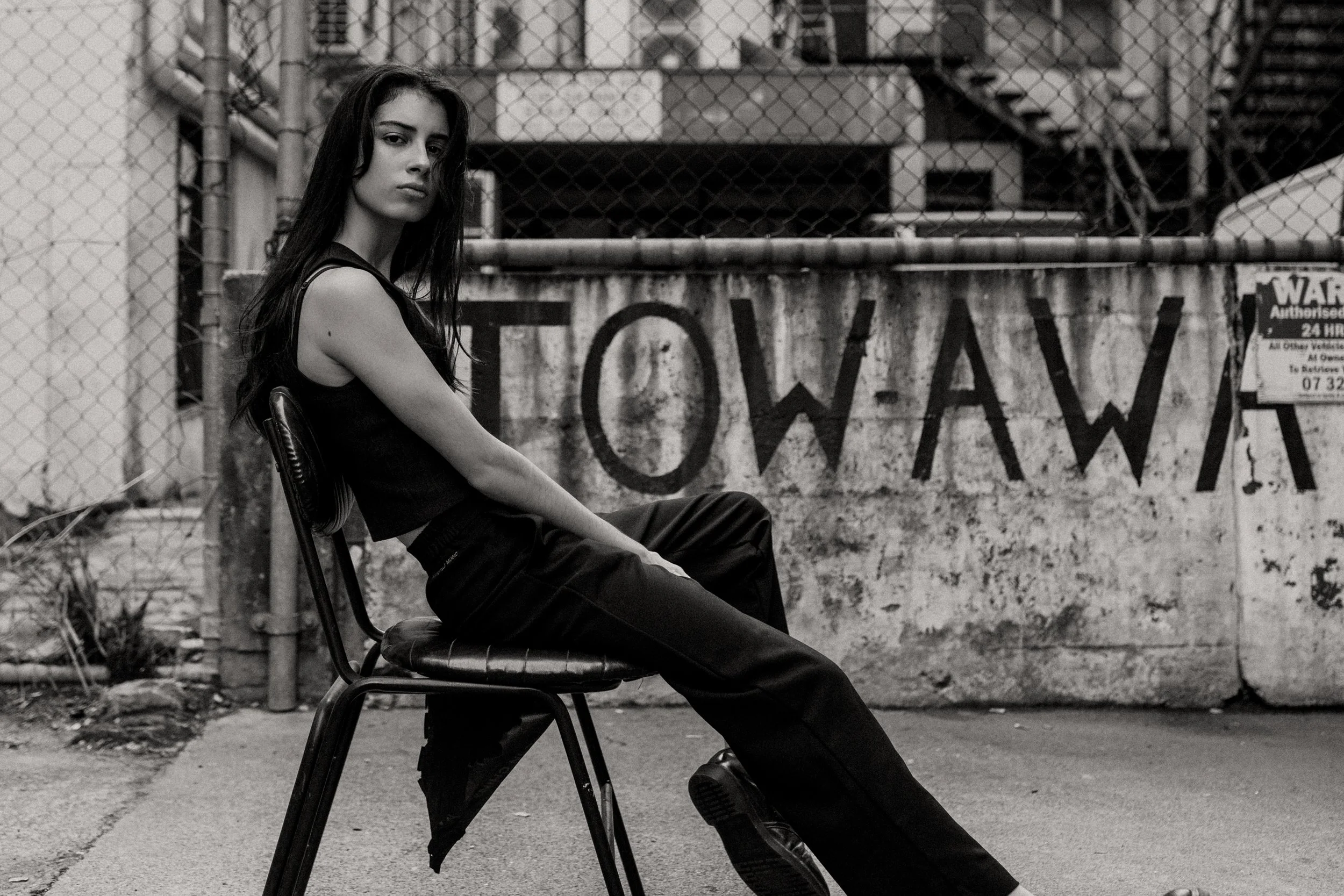 Young musician sits in Tow Away zone for Spotify album photos.