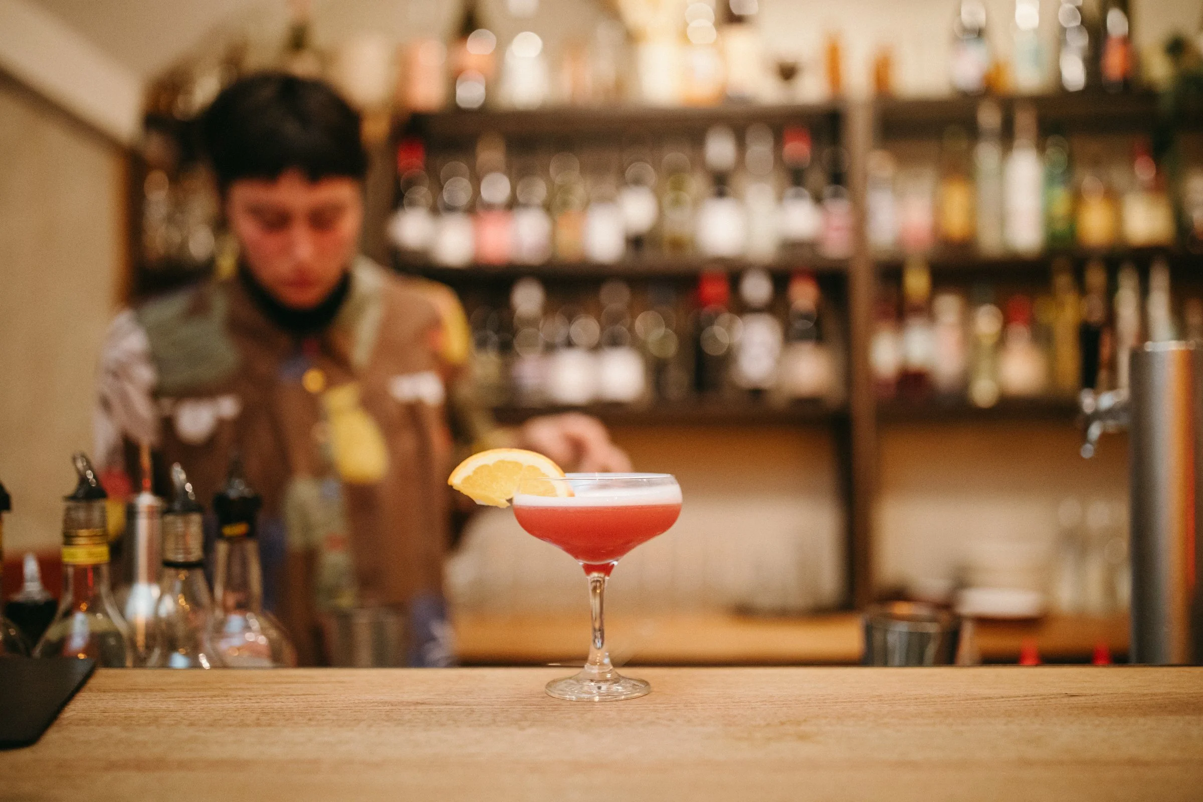 Cocktail sits on bar at restaurant.