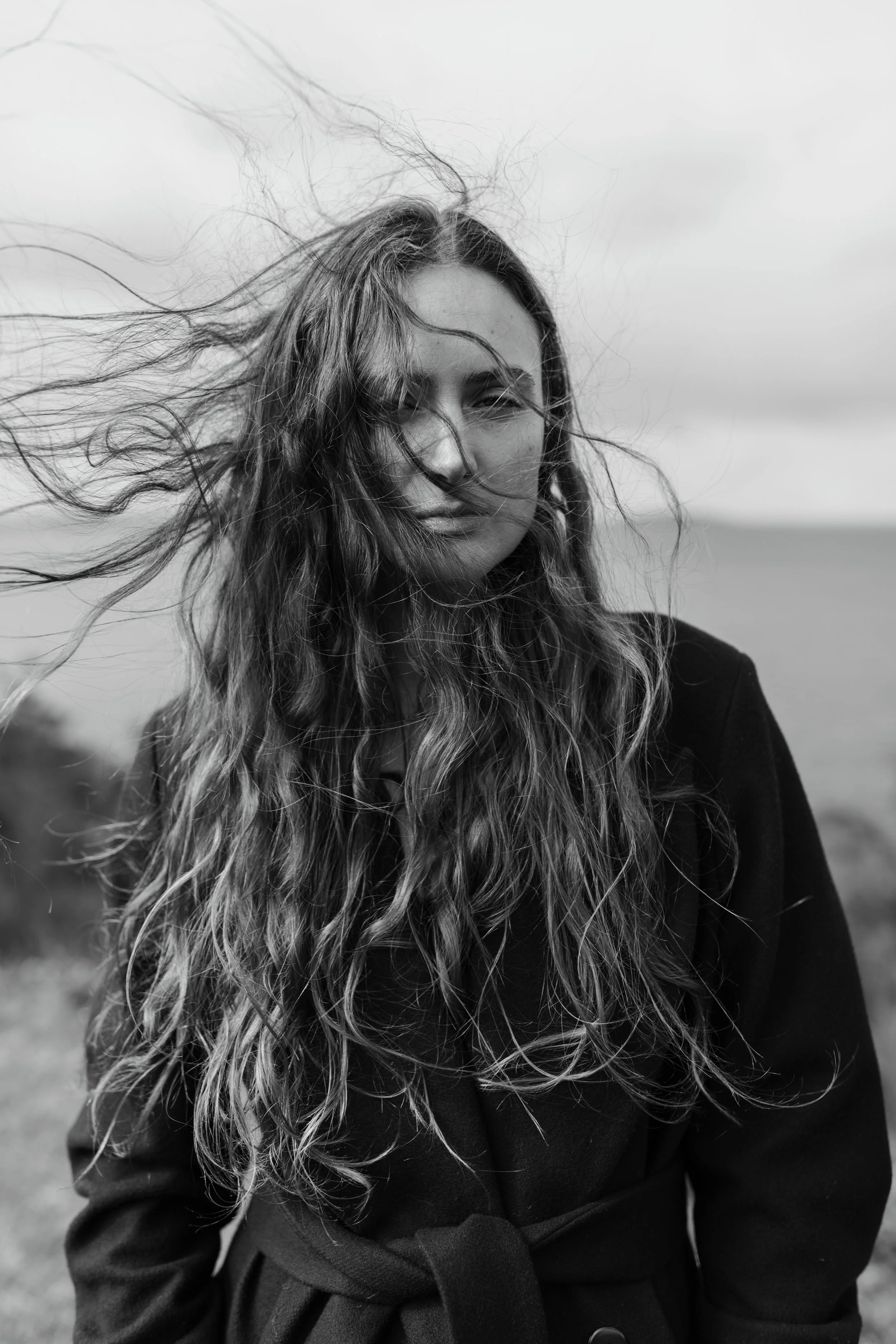 Close up of woman with long, wavy hair for commercial fashion shoot.