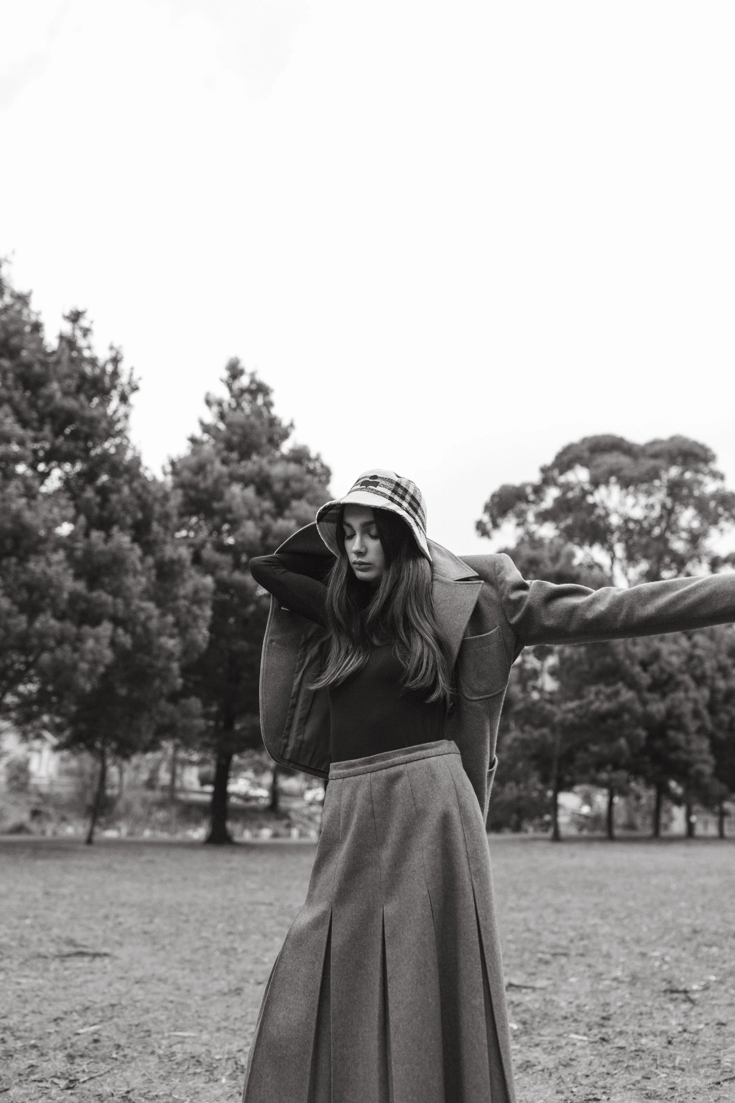 Model stretches arms to put jacket on.