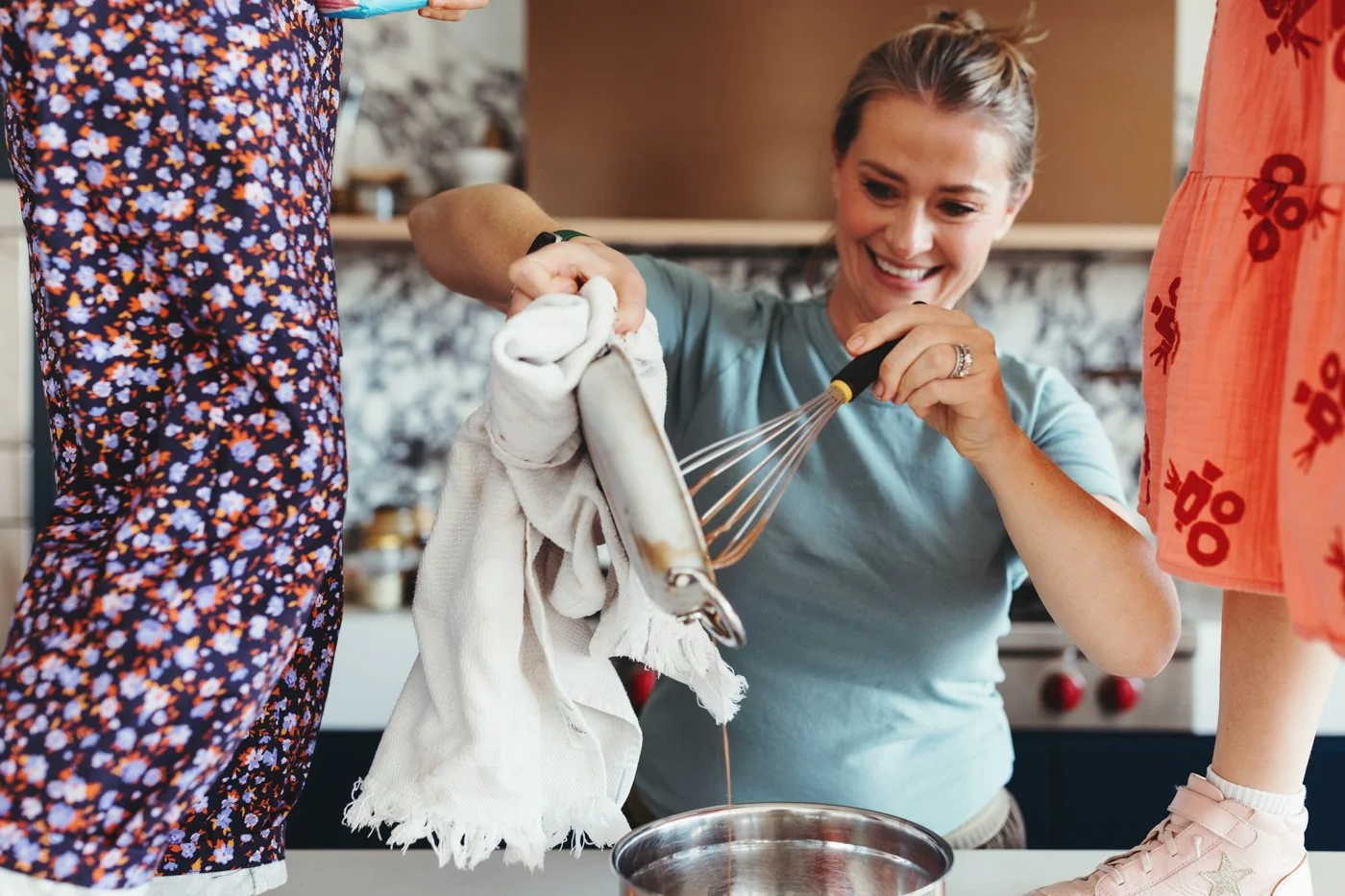 Katrina Meynink pours liquid into bowl during commercial photo shoot.