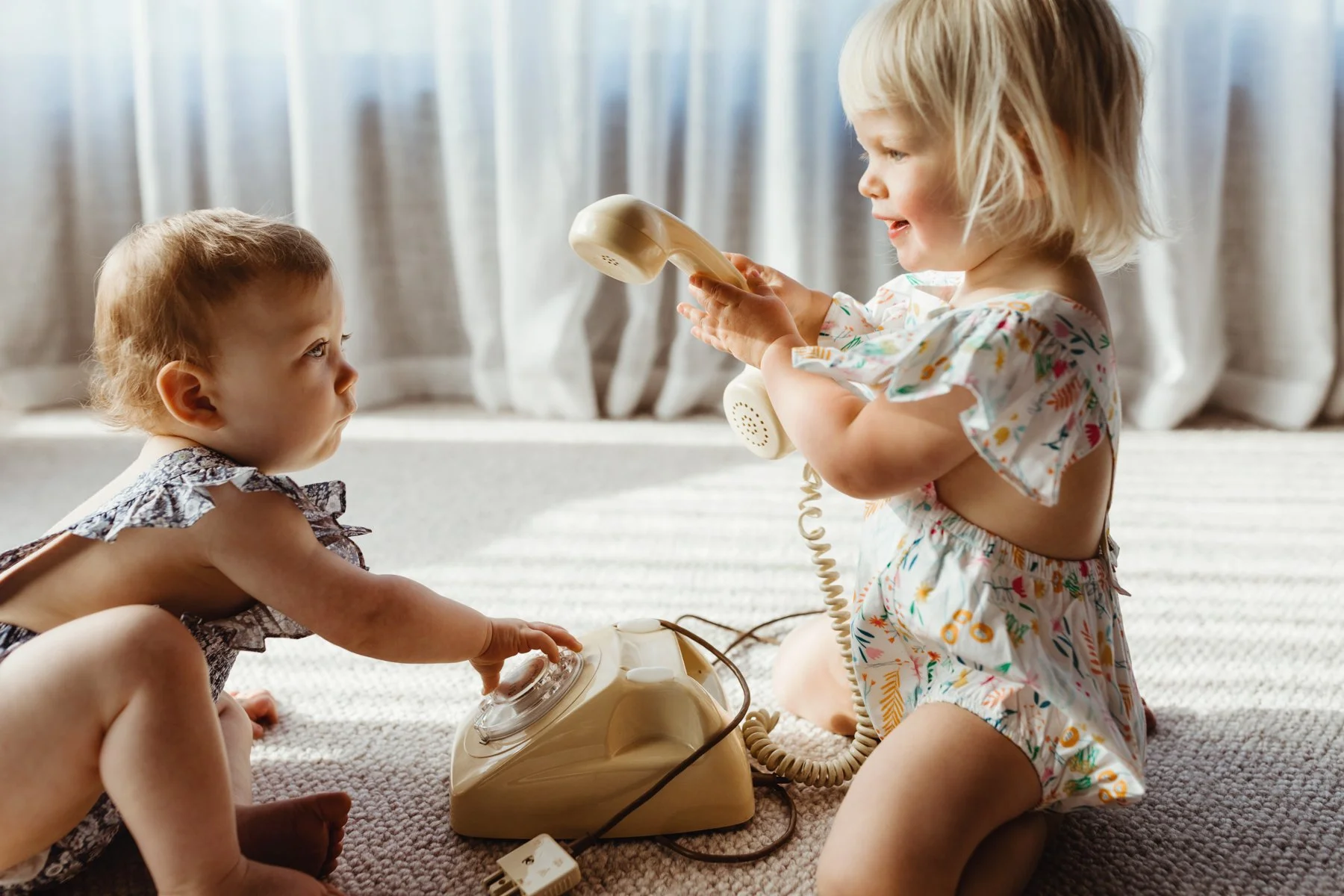Babies play with telephones in photo shoot in Tasmania.