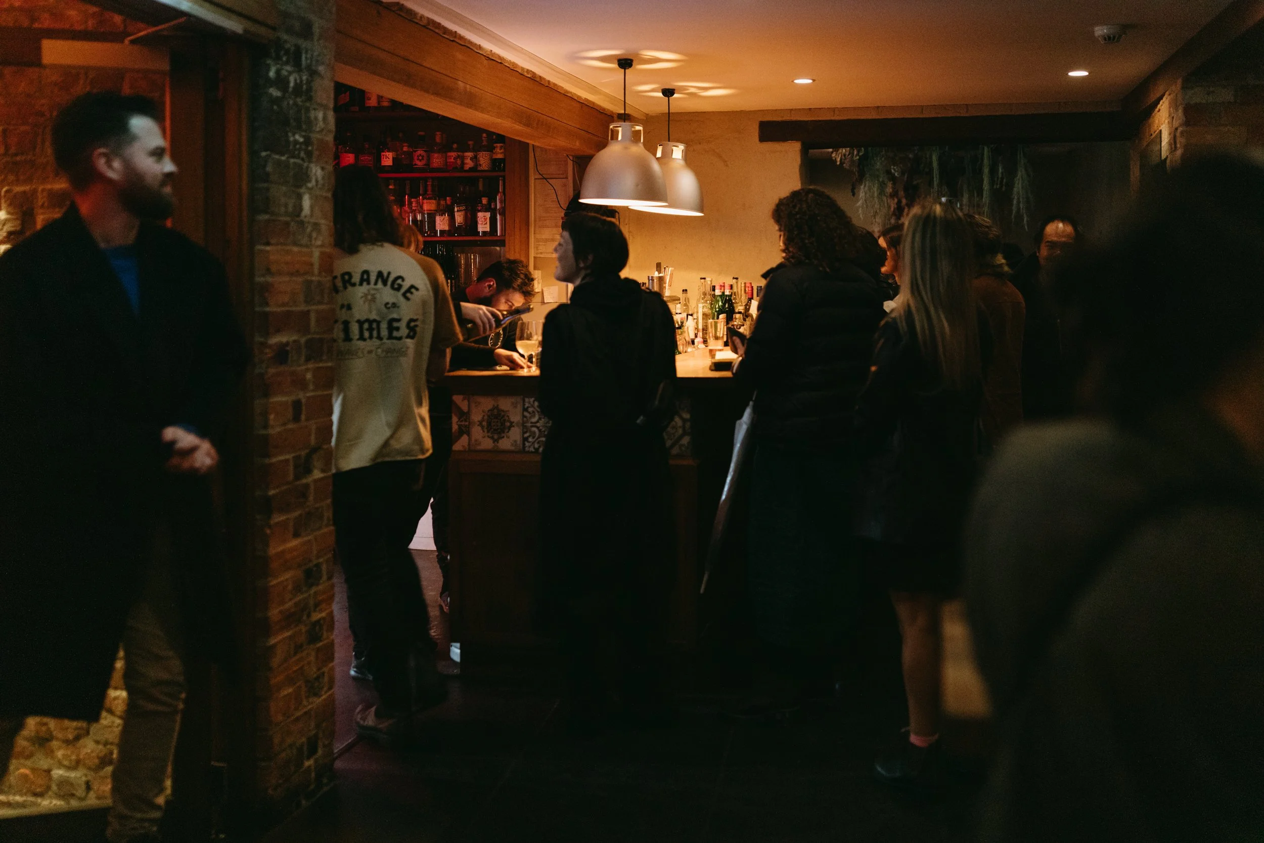 Event photography in busy and cozy Tasmanian bar.