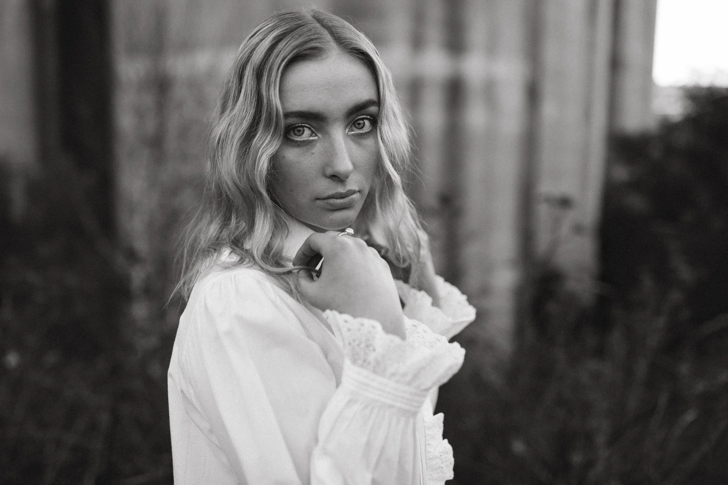 Model holds collar of shirt for photo shoot in South Hobart.