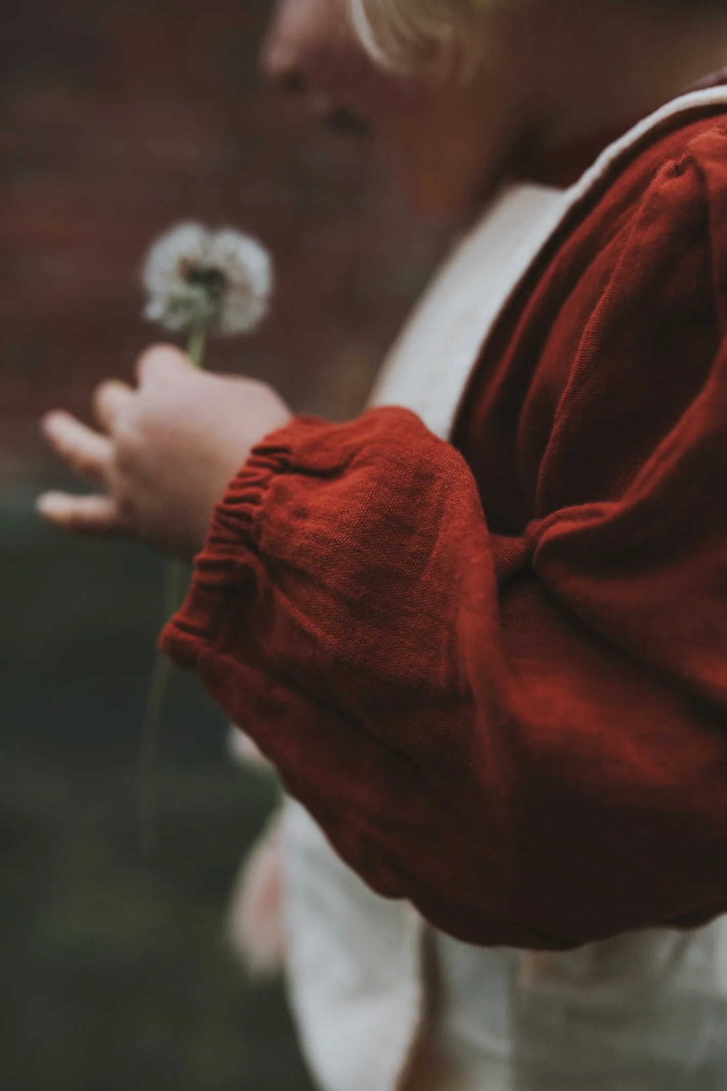 Girl holds flower.