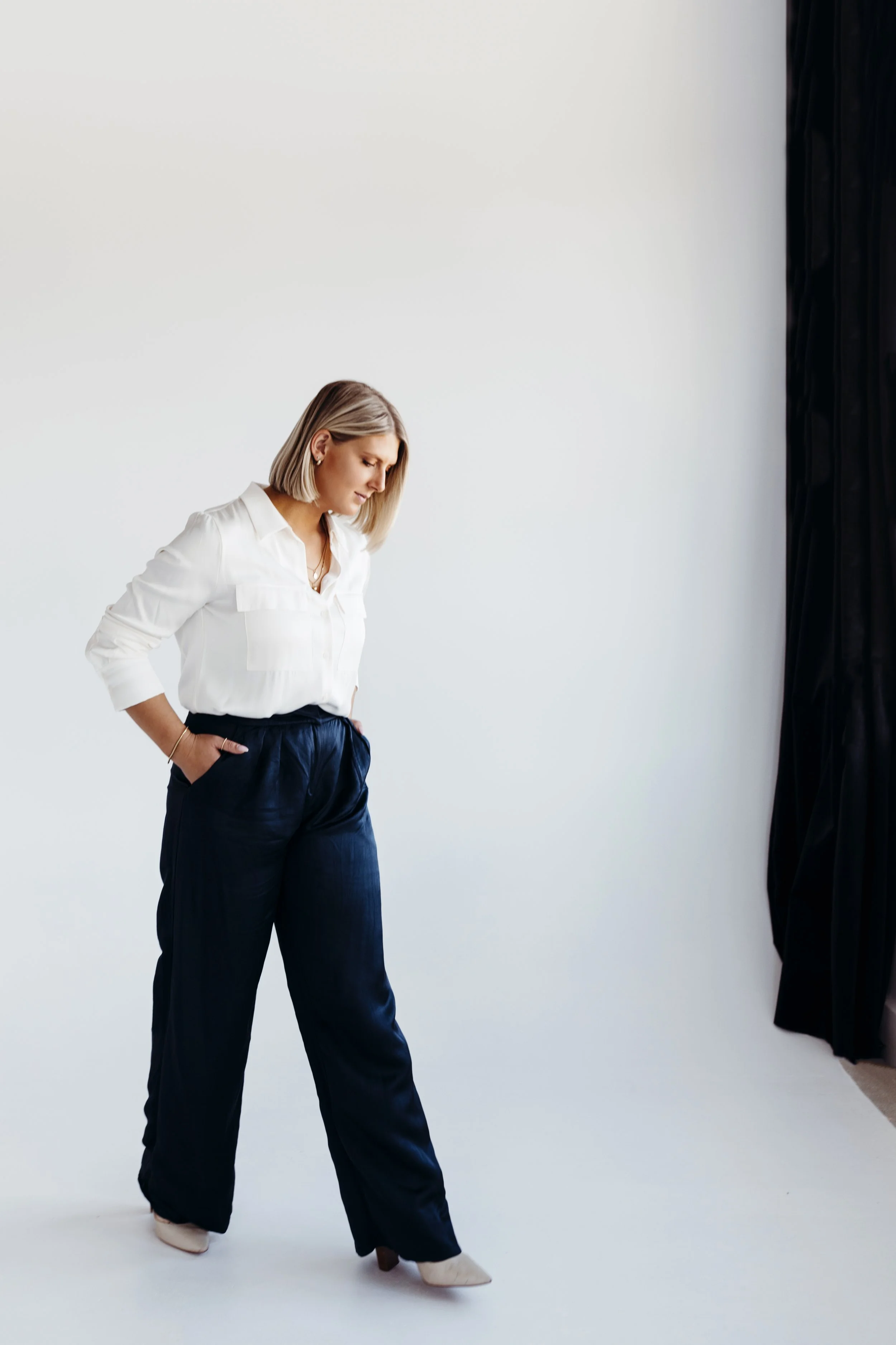 Woman walks through studio during branding photo session.
