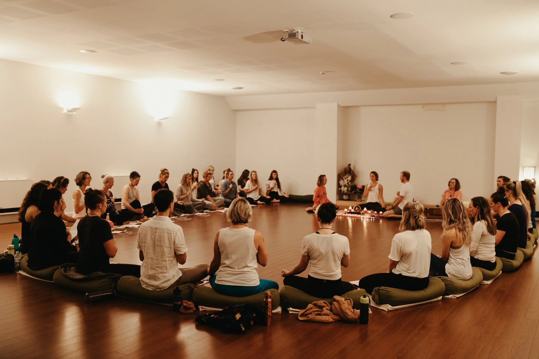 Circle of yogis during yoga ceremony in Hobart wellness studio.