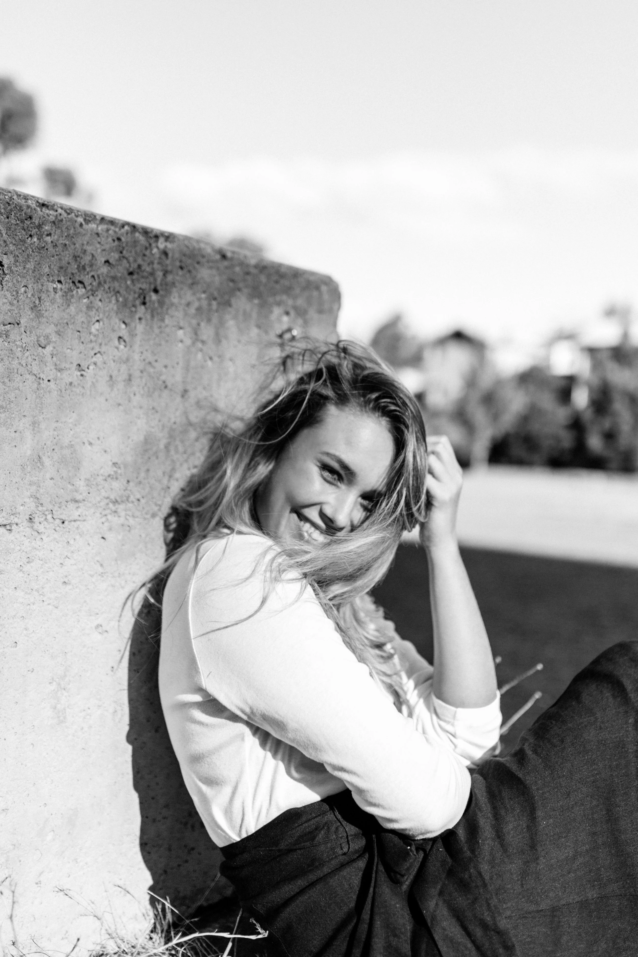 Woman sits and laughs naturally for model test shoot in Hobart, Tasmania.
