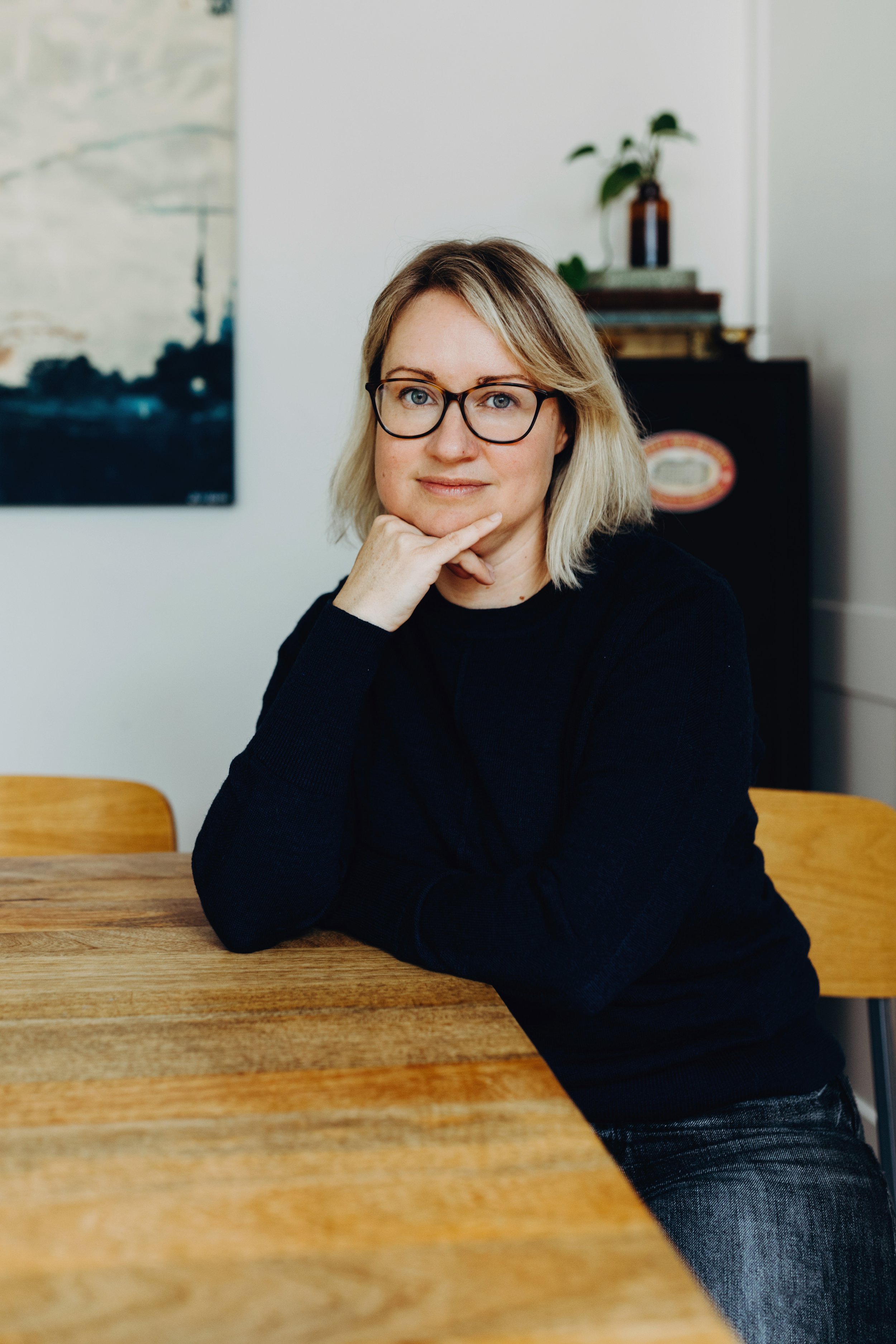 Blogger and writer sits for photo session for website bio.