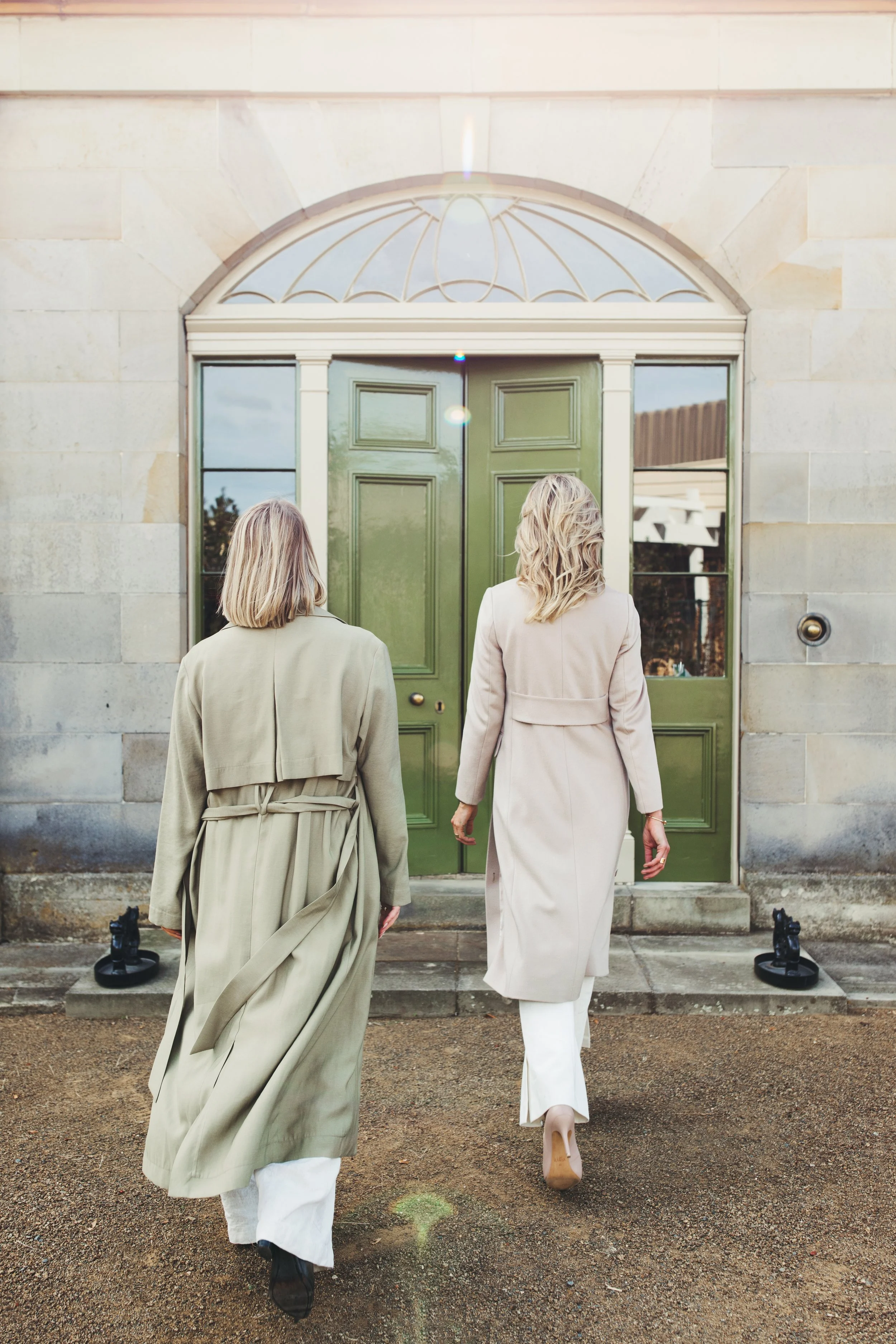 Two buyer's agents walk into historical building in Hobart.