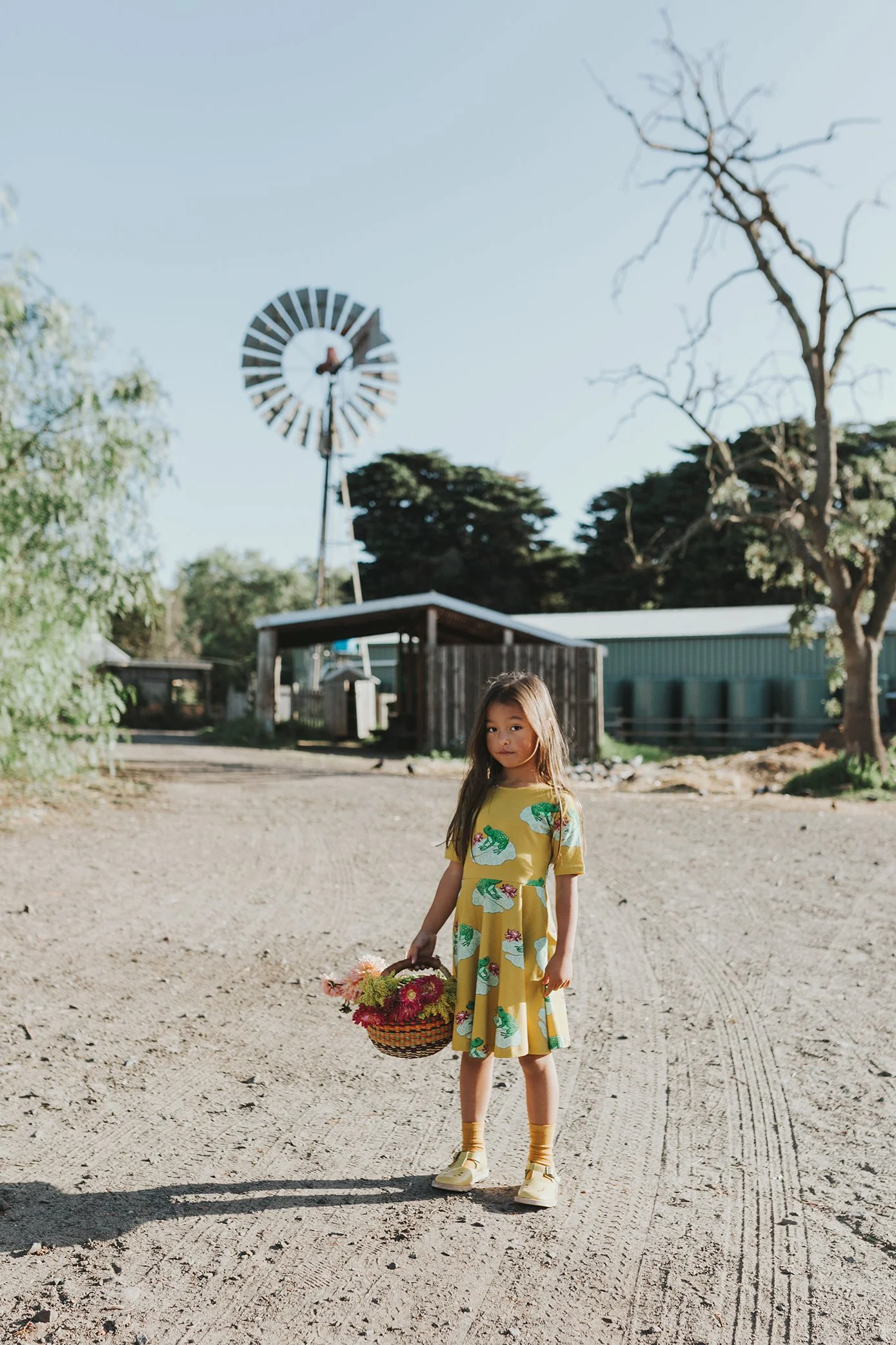 Girl poses with basket of flowers for commercial photography in Melbourne.