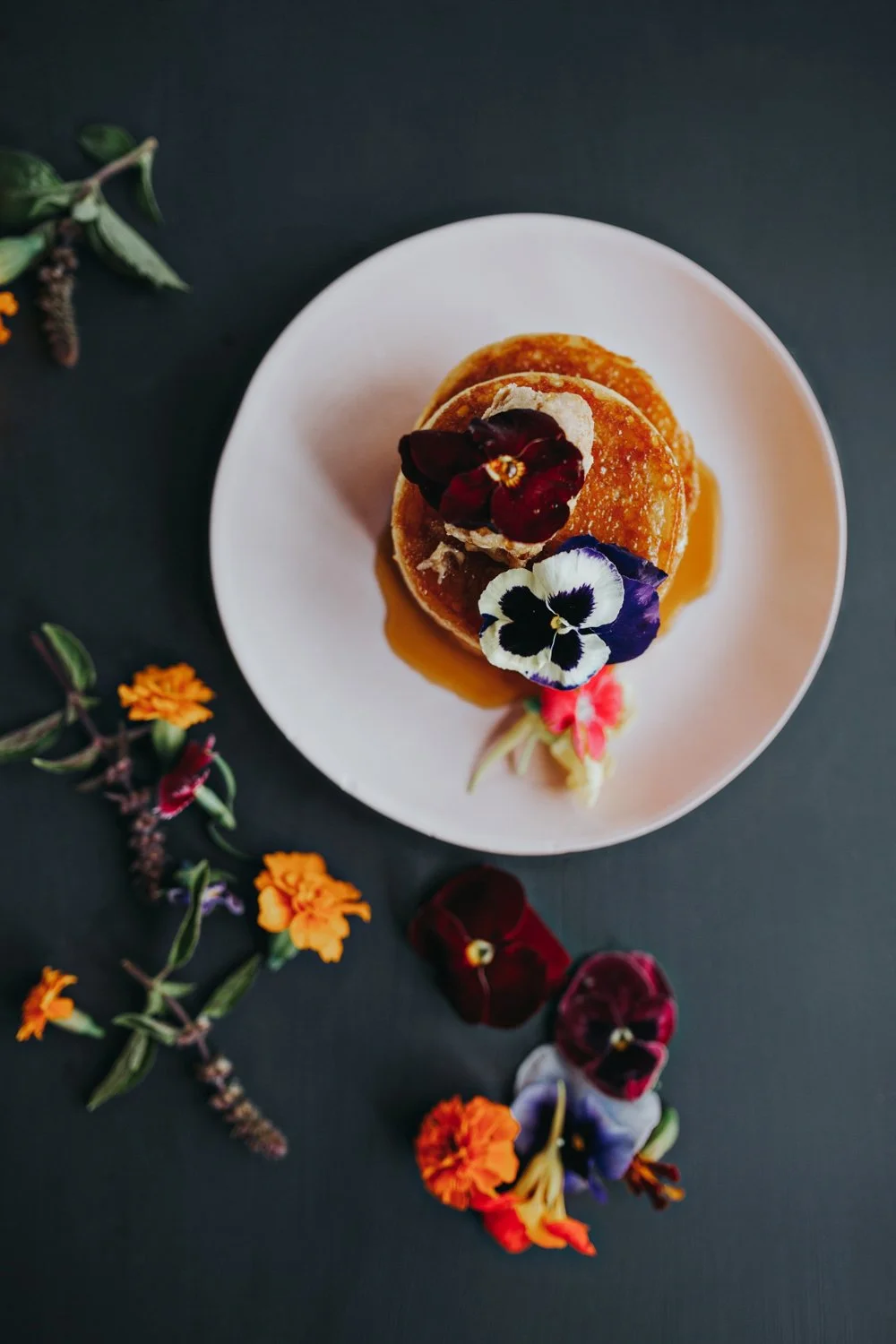 Overhead photo of pikelets on kitchen bench for recipe book photo session.