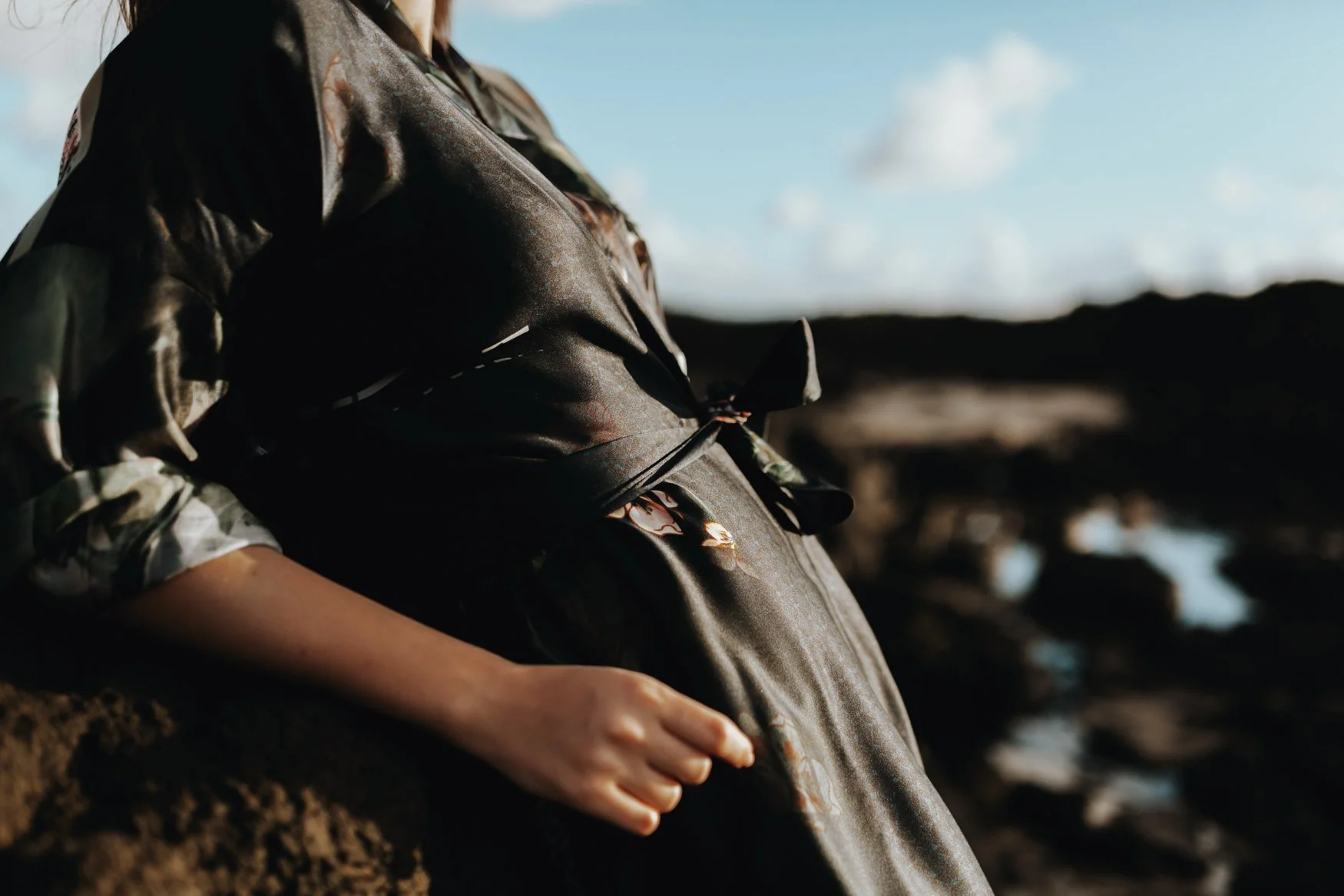 Woman poses in silk kimono for fashion photo shoot in Byron Bay.