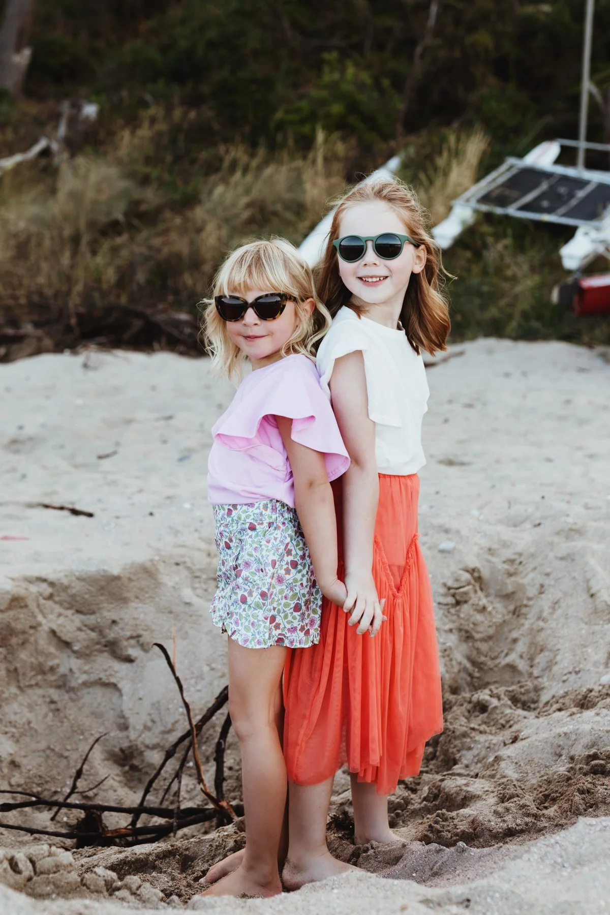 Girls smile as they stand back to back and pose for photos.