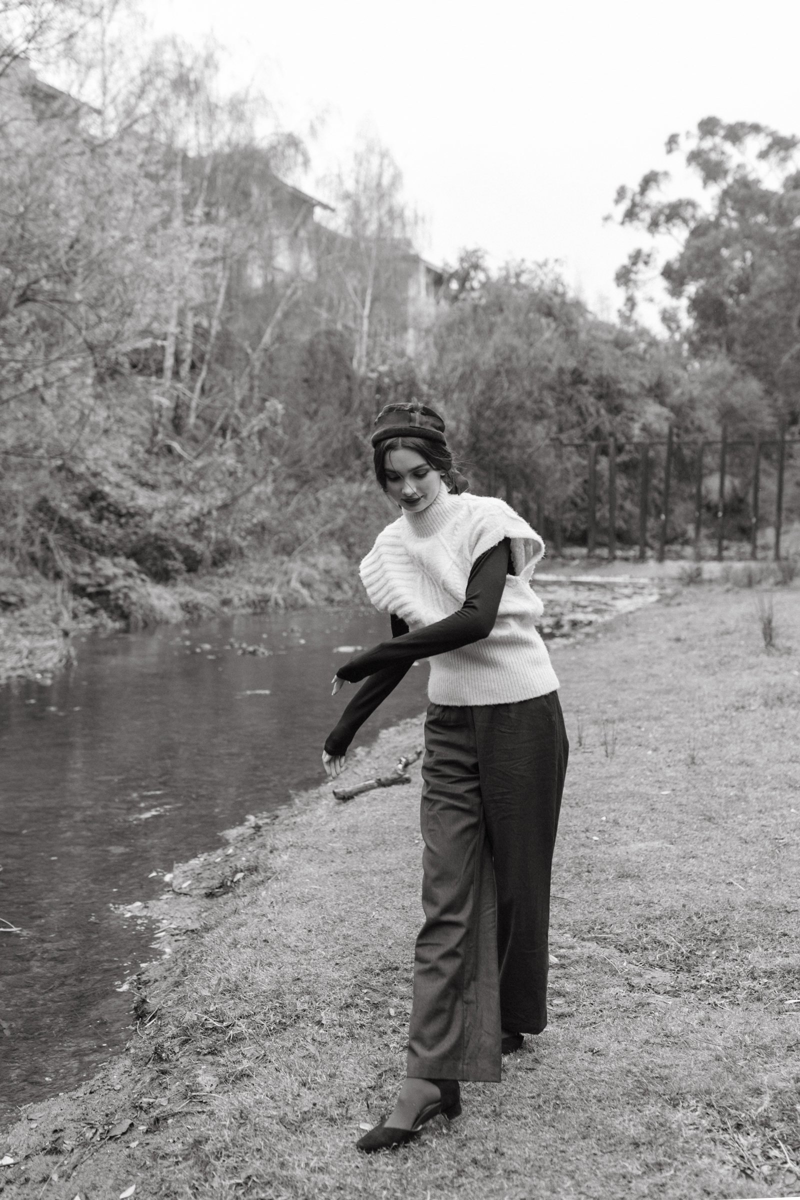Model strolls playfully during fashion photo shoot.