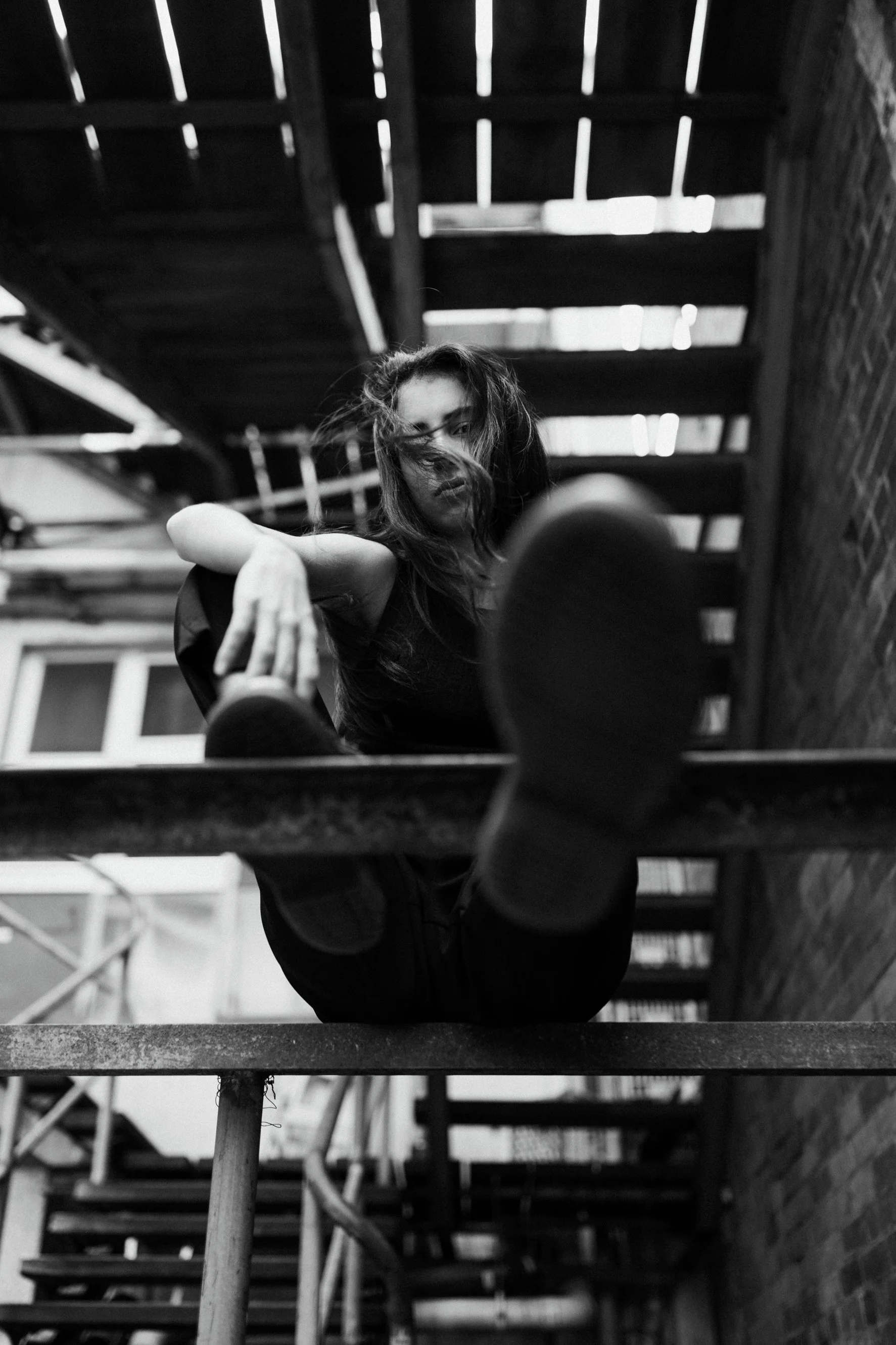 Young musician poses in alleyway for album cover.