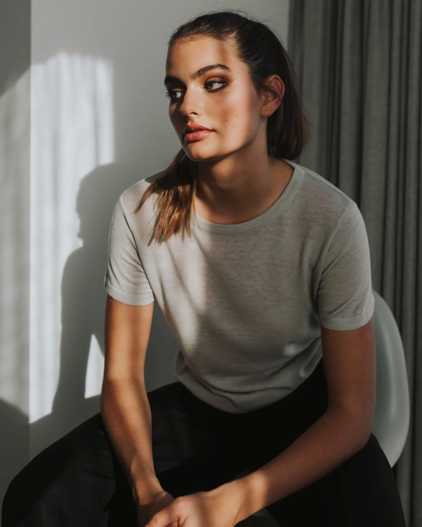 Model poses in high end hotel for fashion label shoot.