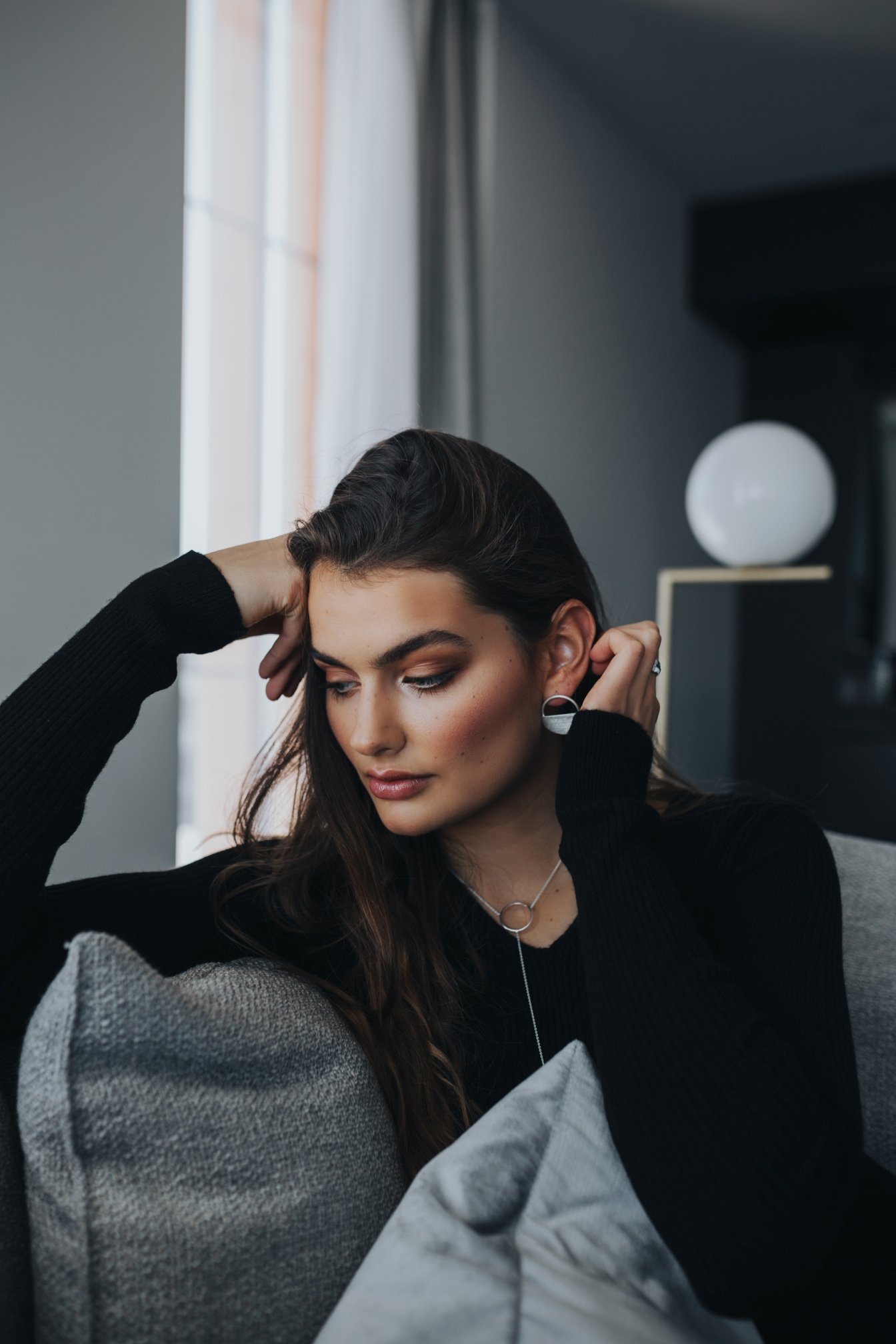 Woman leans into sofa in hotel in Hobart, Tasmania.