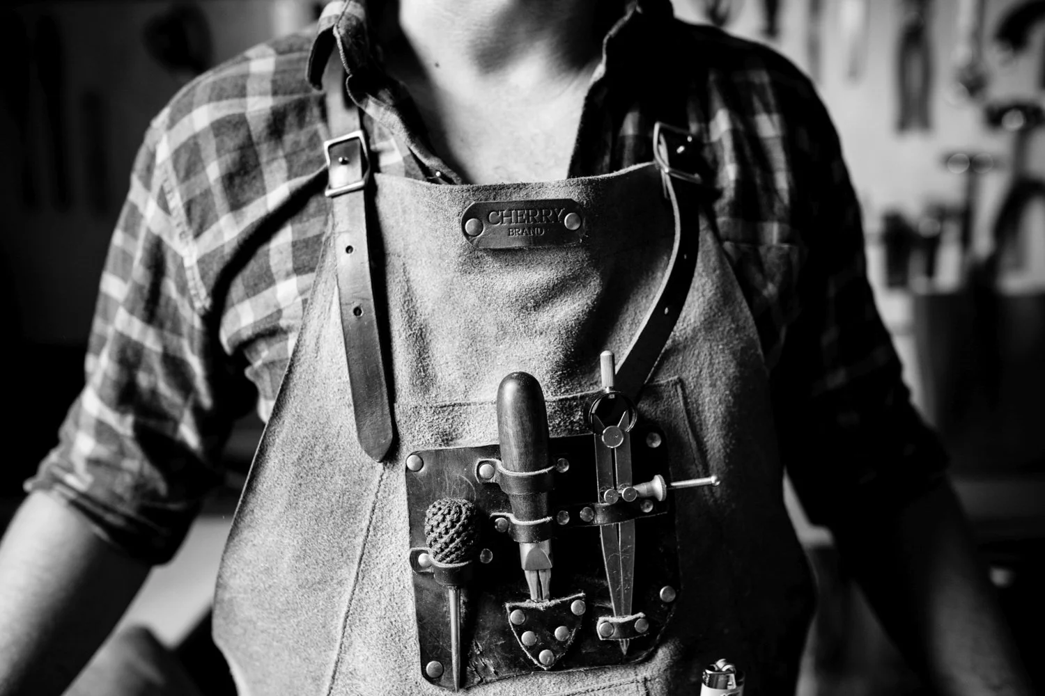 Natural photograph of tools in leather apron.