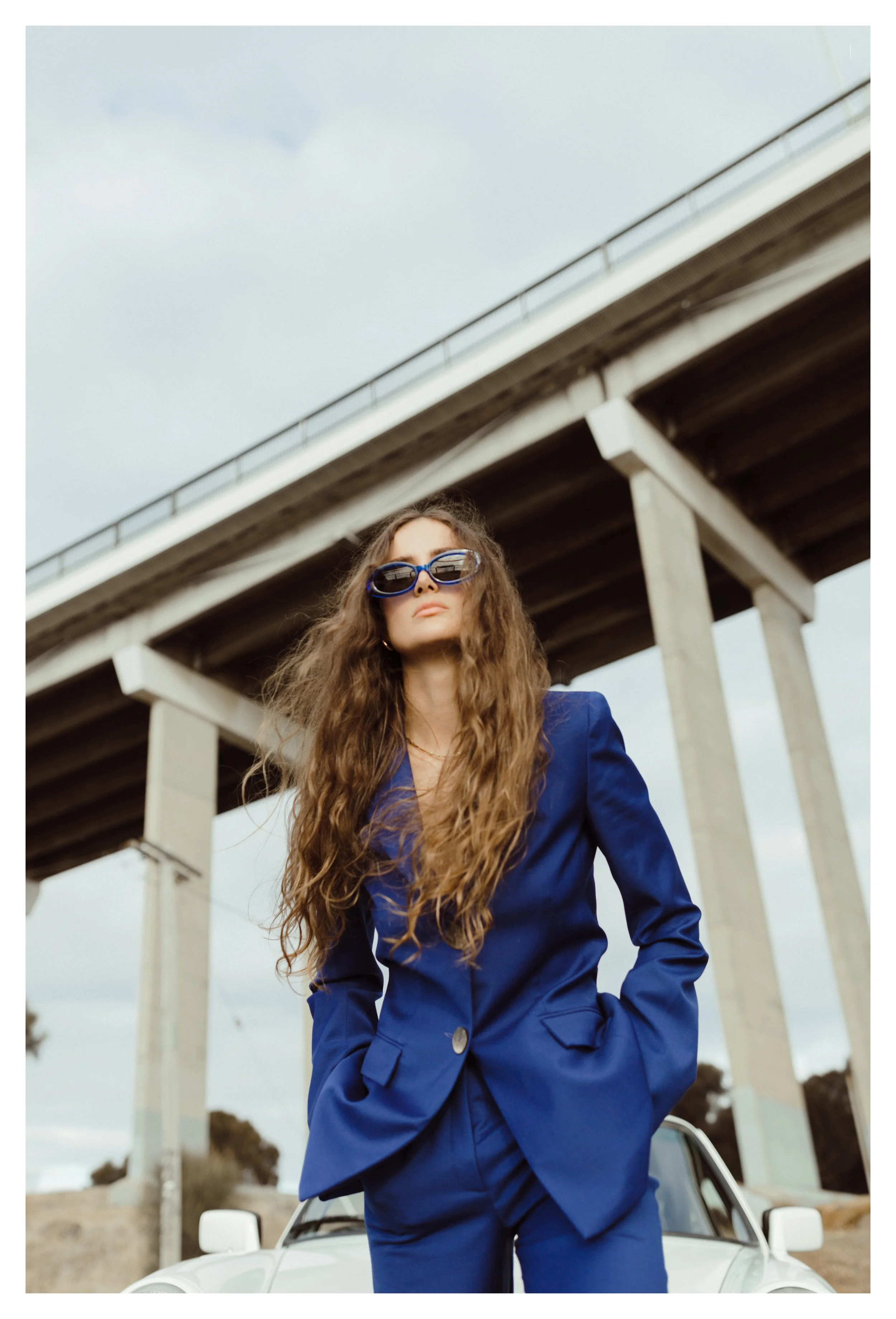 Model poses under a bridge in Tasmania.