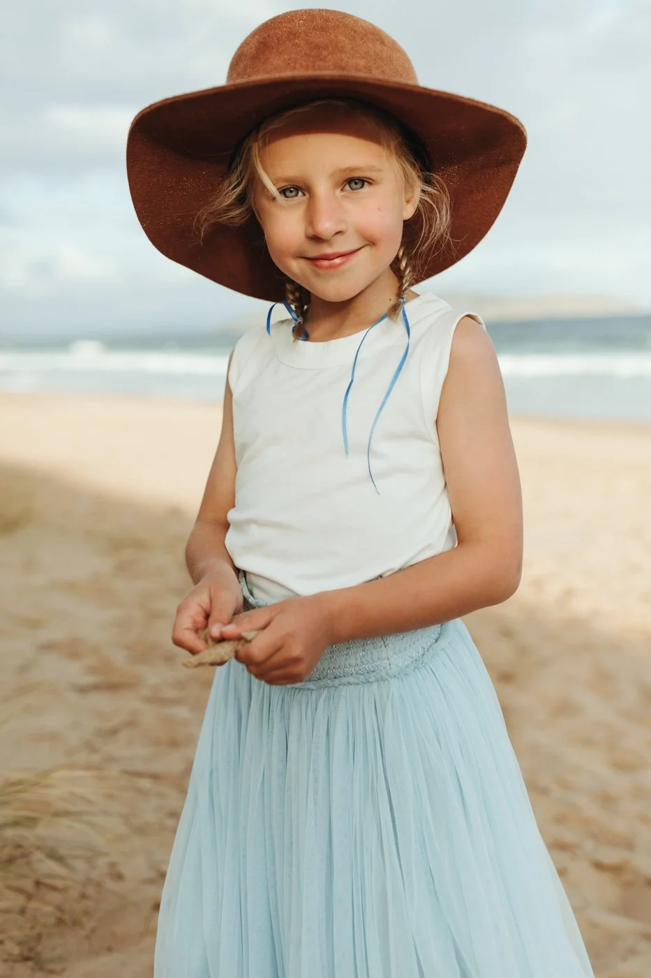 Photo of blonde girl at beach at sunset photo shoot.