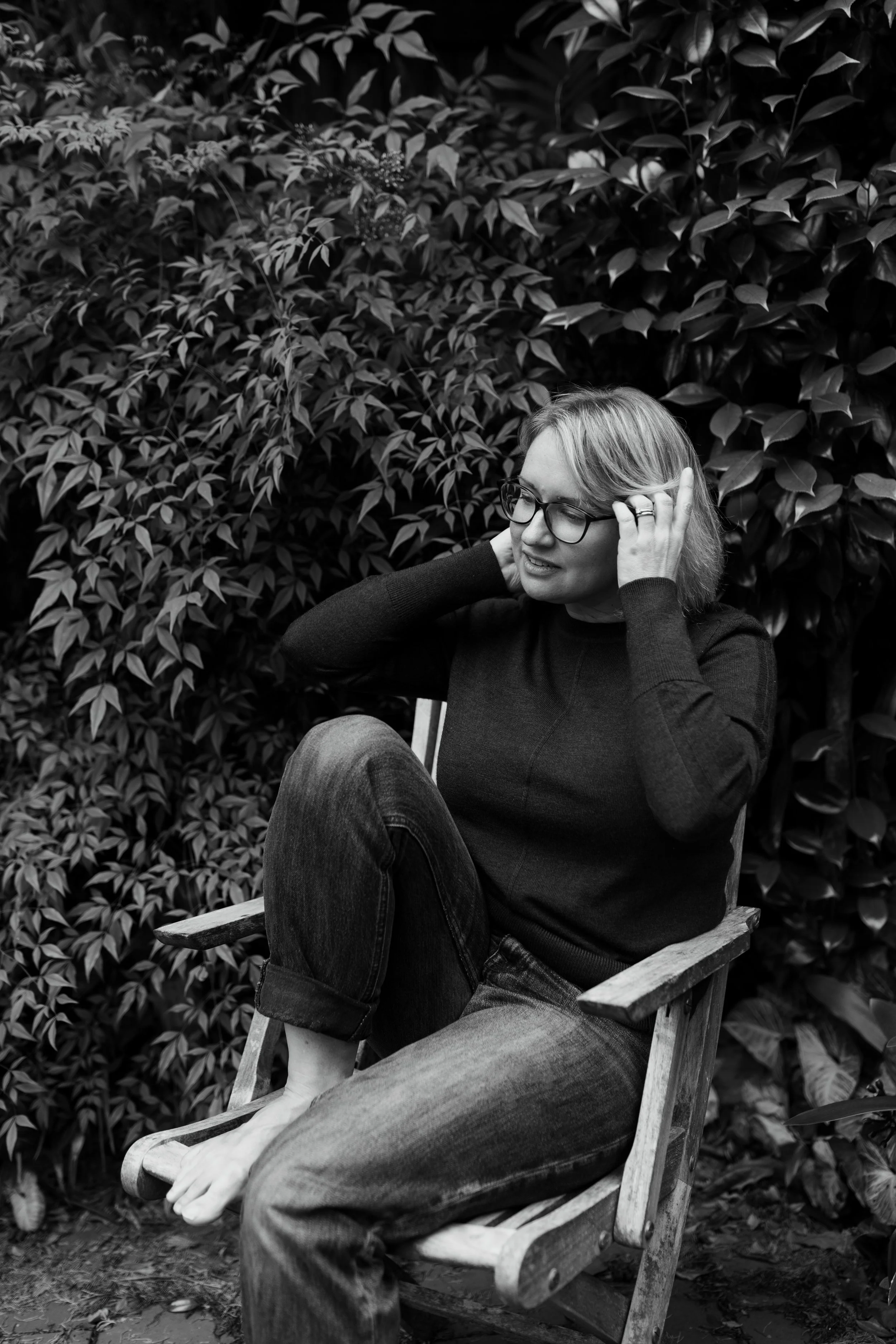 Writer naturally poses in garden during lifestyle branding photo shoot in Sydney.