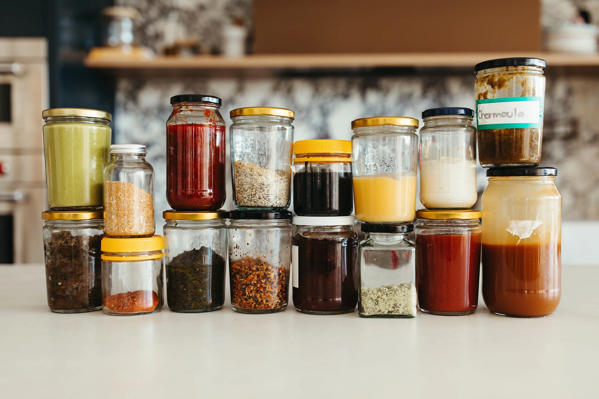 Jars of sauces on kitchen bench for food writer book photography.