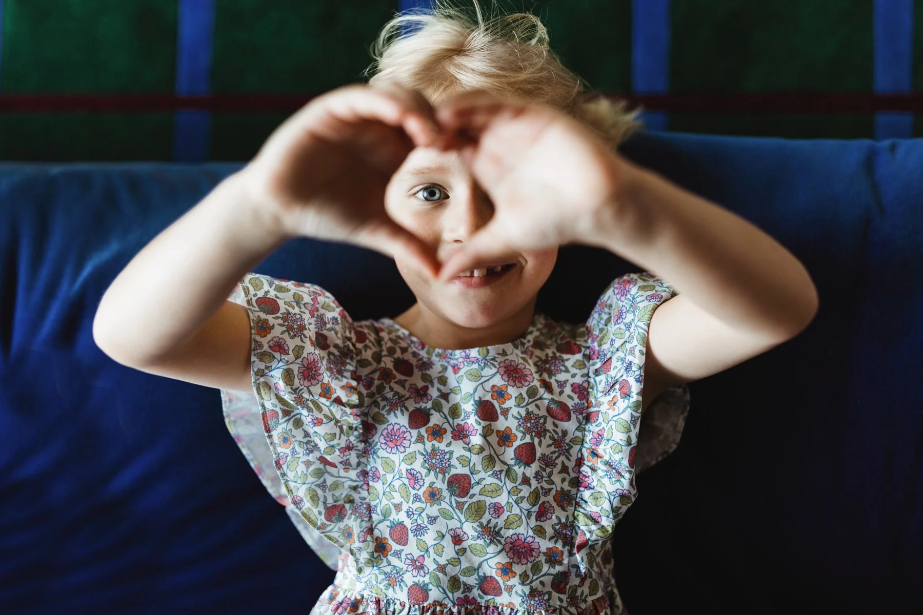Girl shows love heart with hands in Hobart fashion shoot.