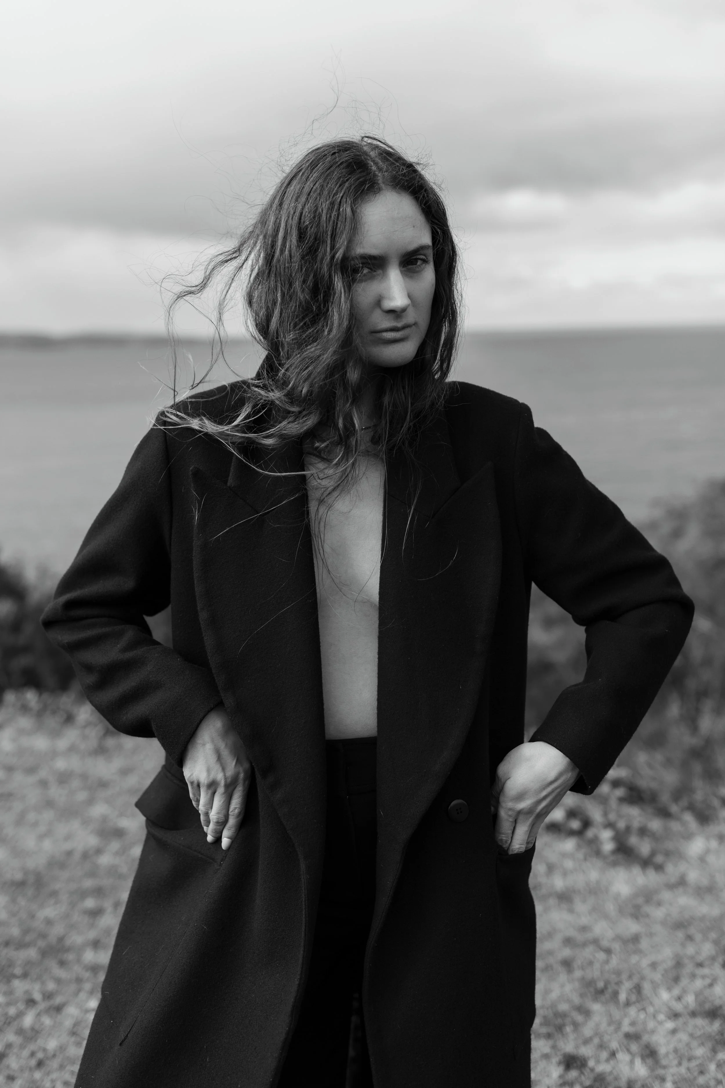 Model poses in black coat for Commercial fashion photo shoot in Tasmania.