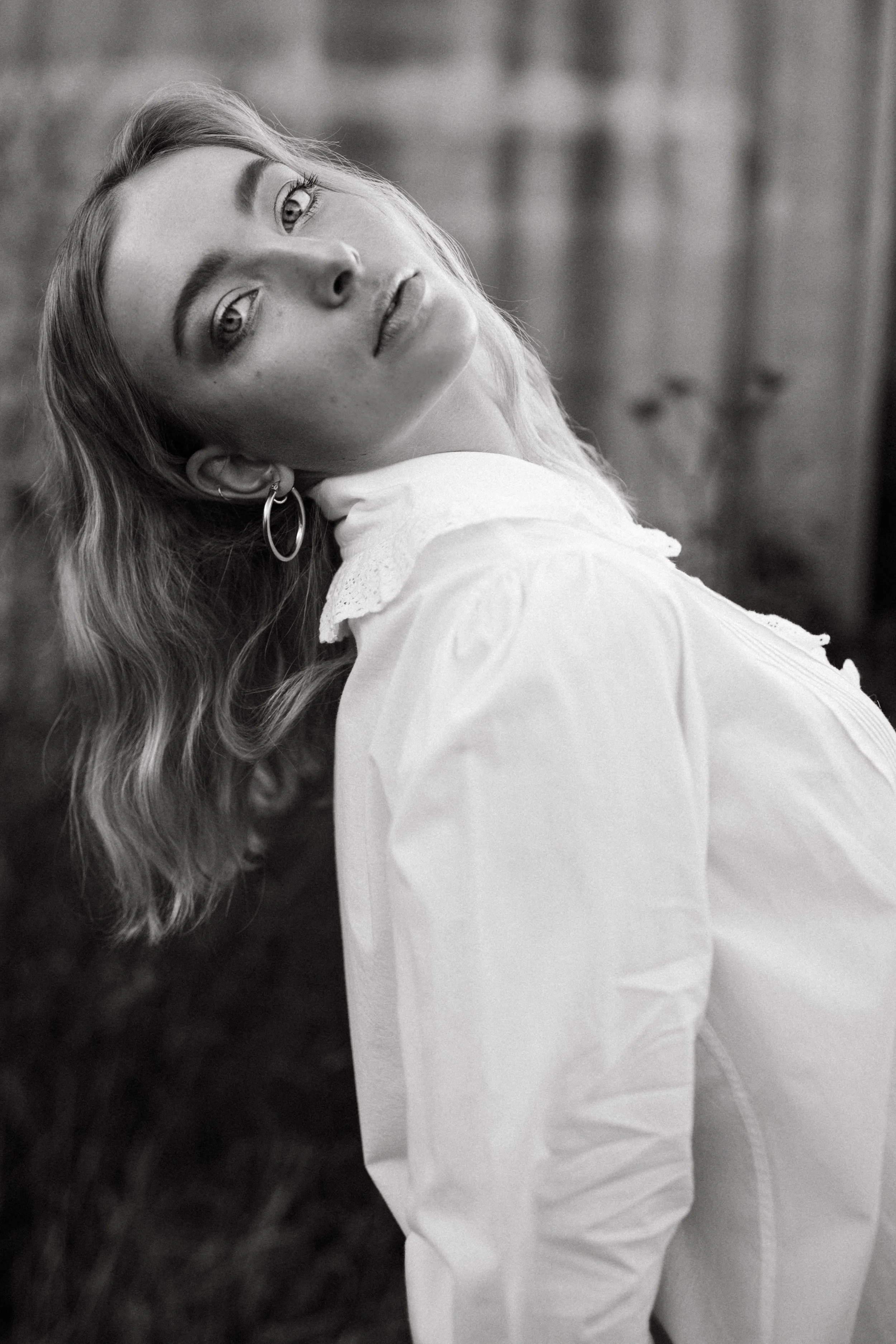 Model leans back in white collared shirt for Hobart fashion shoot.