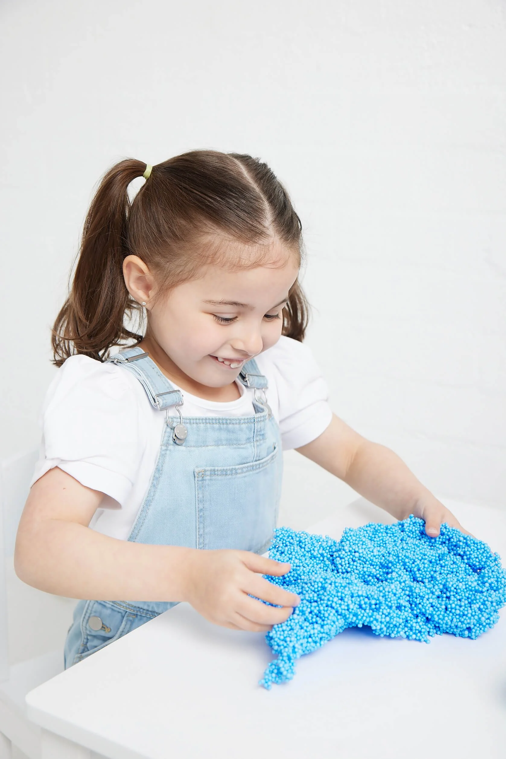 Young child exploring sensory materials during developmental therapy in Adelaide