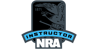 NRA Instructor badge with the year 1871 and the word 'INSTRUCTOR' on a blue ribbon.