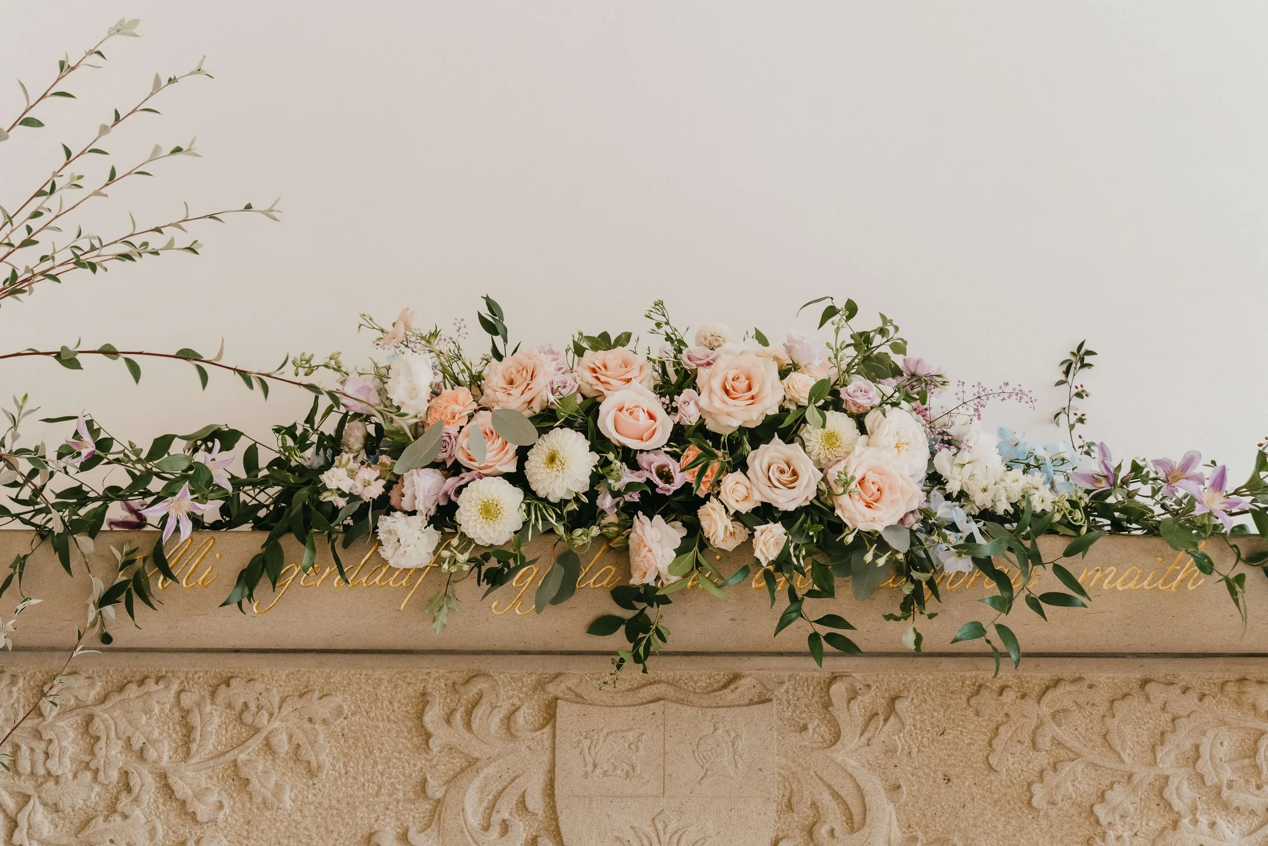 luxurious elegant florals for a wedding ceremony mantlepiece