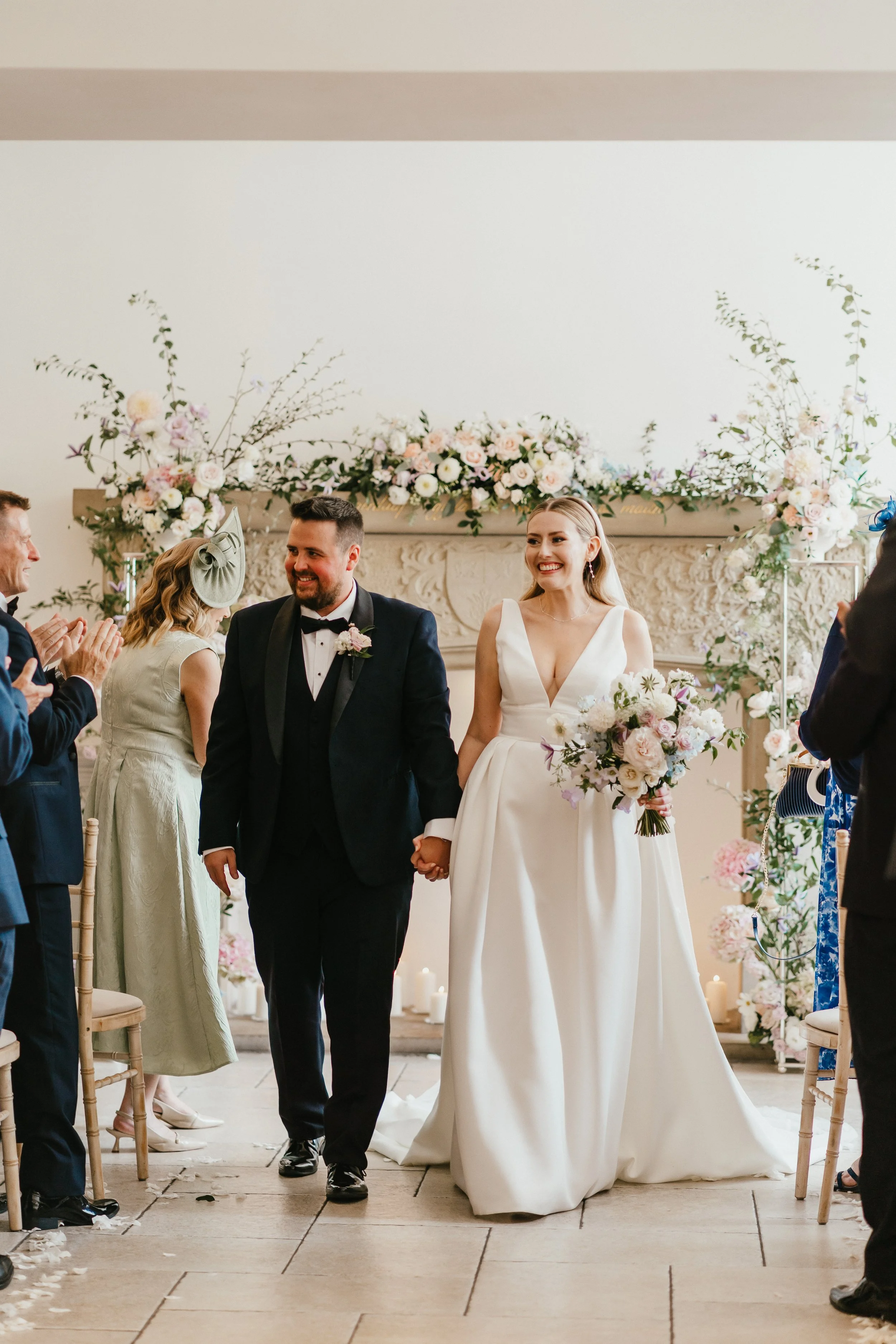 Soft August wedding Ceremony at  Tyn Dwr Hall with layers of delicate pastel florals