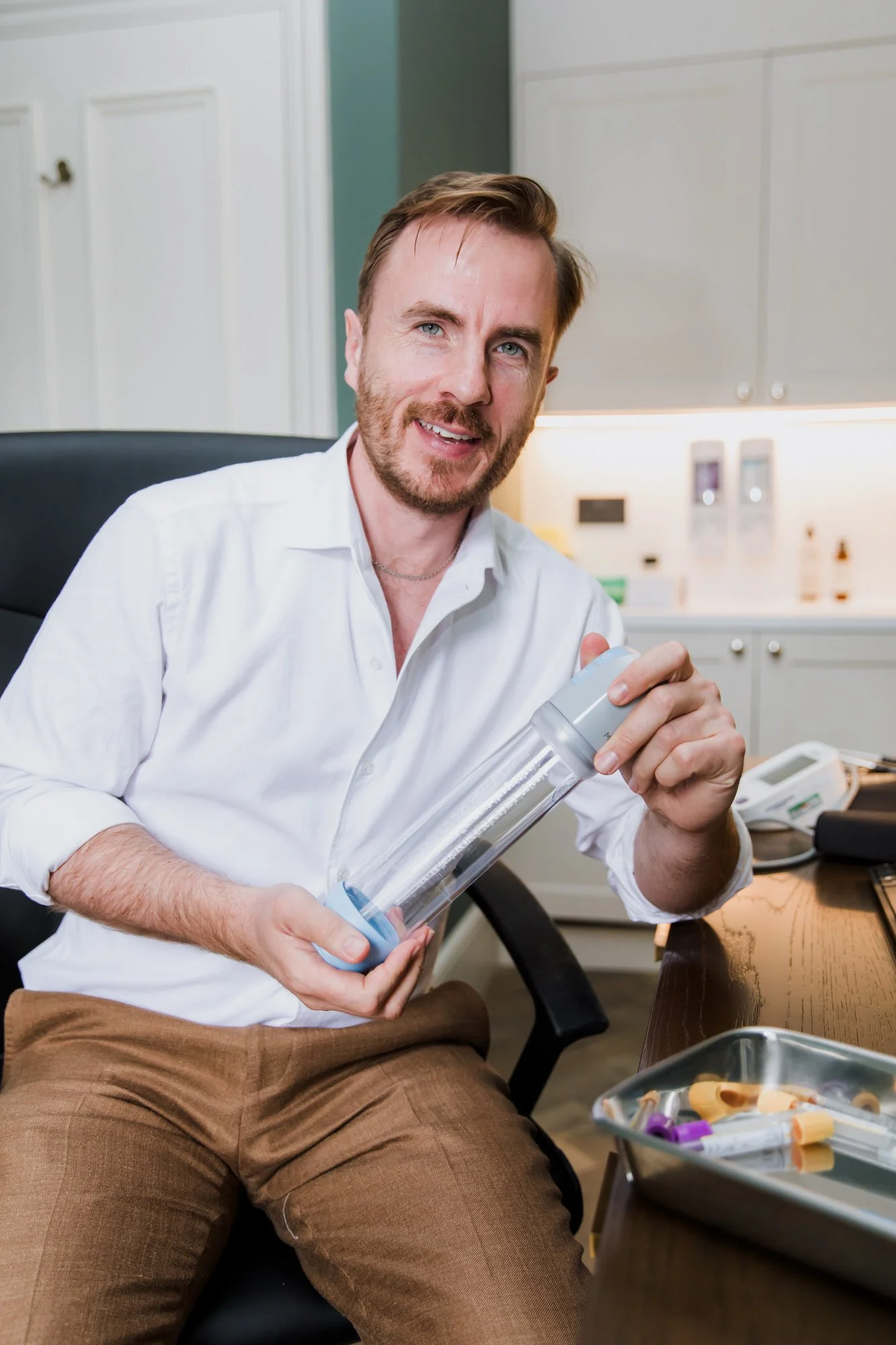 Men's Health Doctor with a Vacuum Erectile Device and Blood Test Kit and Blood pressure monitor in central london clinic