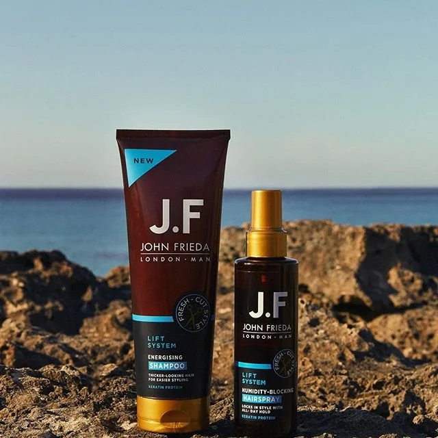 John Frieda London Man shampoo and hairspray on rocks by the sea