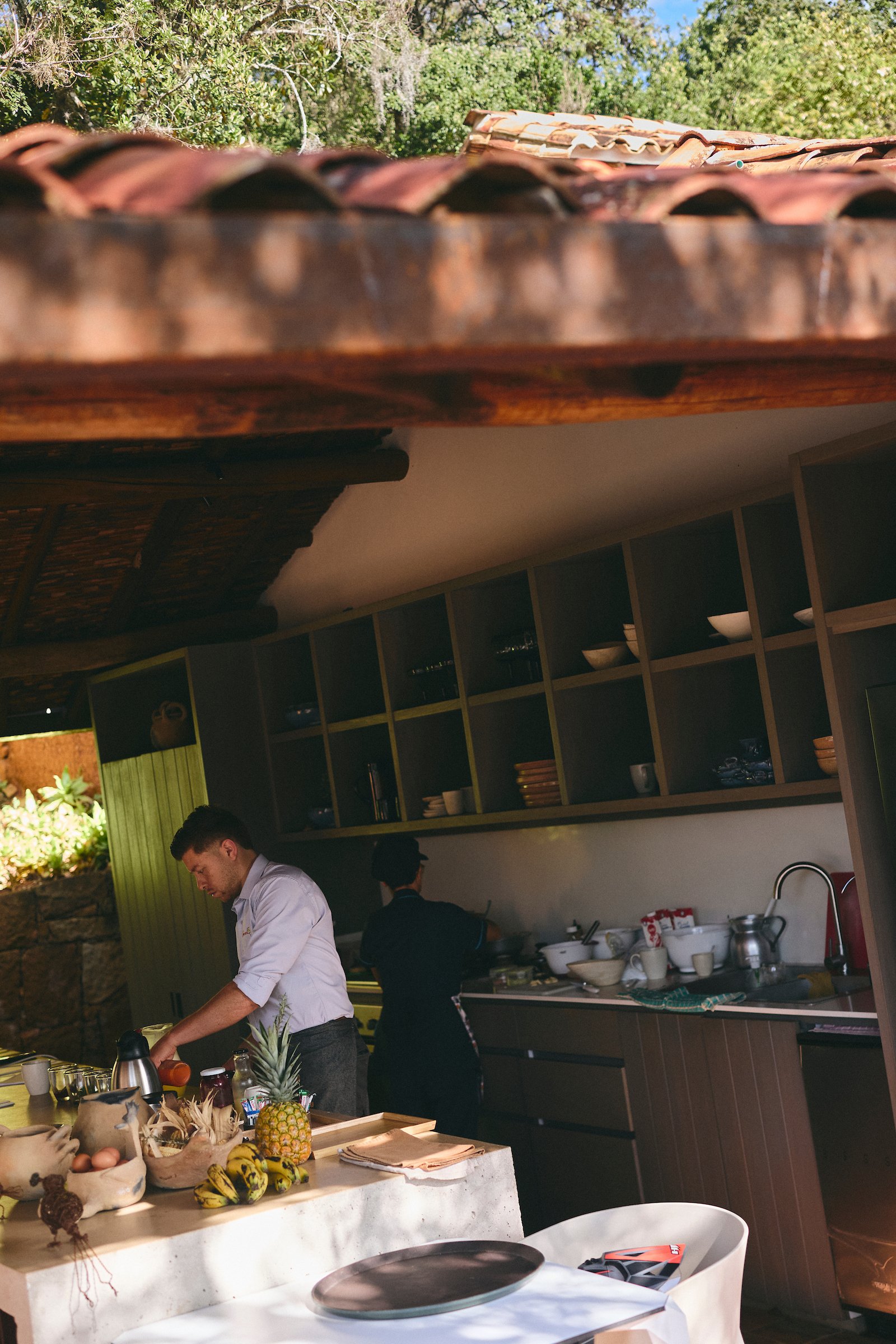 Hotel kitchen at Terrazul in Barichara, Colombia, with staff preparing fresh breakfast to be served on the terrace overlooking the forest