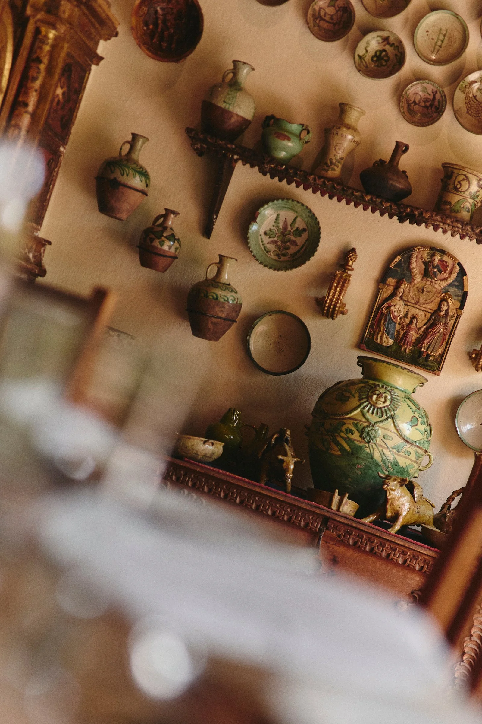 Colonial ceramics and devotional art displayed inside Hacienda Huayoccari, a private Sacred Valley estate featured by luxury Peru DMC WhereNext Travel.