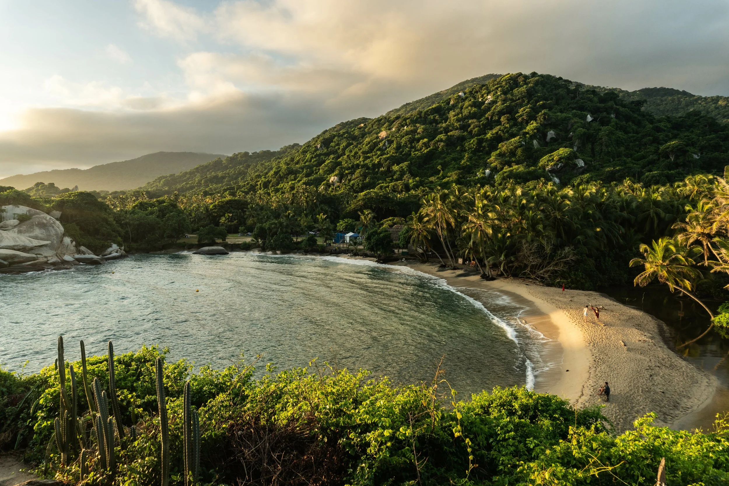 Aerial view of a sandy beach and turquoise Caribbean water at Tayrona National Park in Colombia.