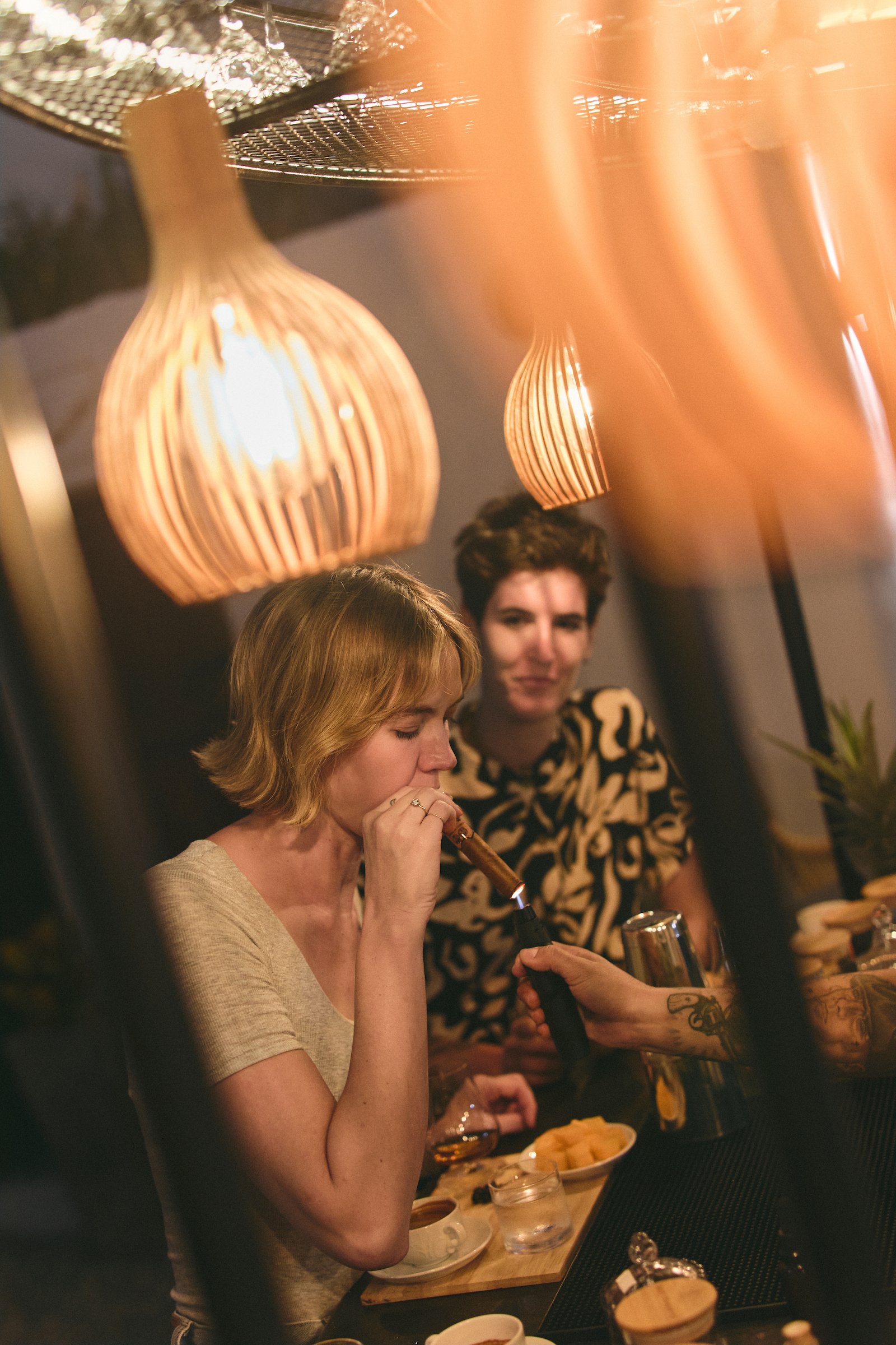 Guests smoking Colombian cigars at the bar inside Bribón’s factory in Barichara.