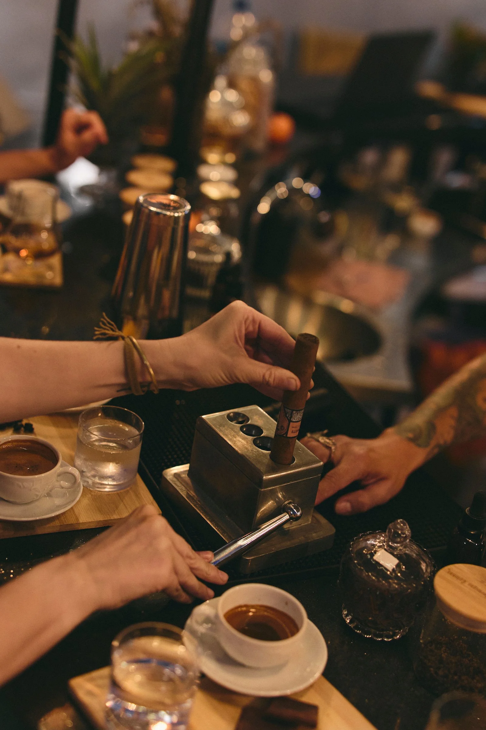 Guest cutting a handmade Bribón cigar at the factory bar in Barichara, Colombia.