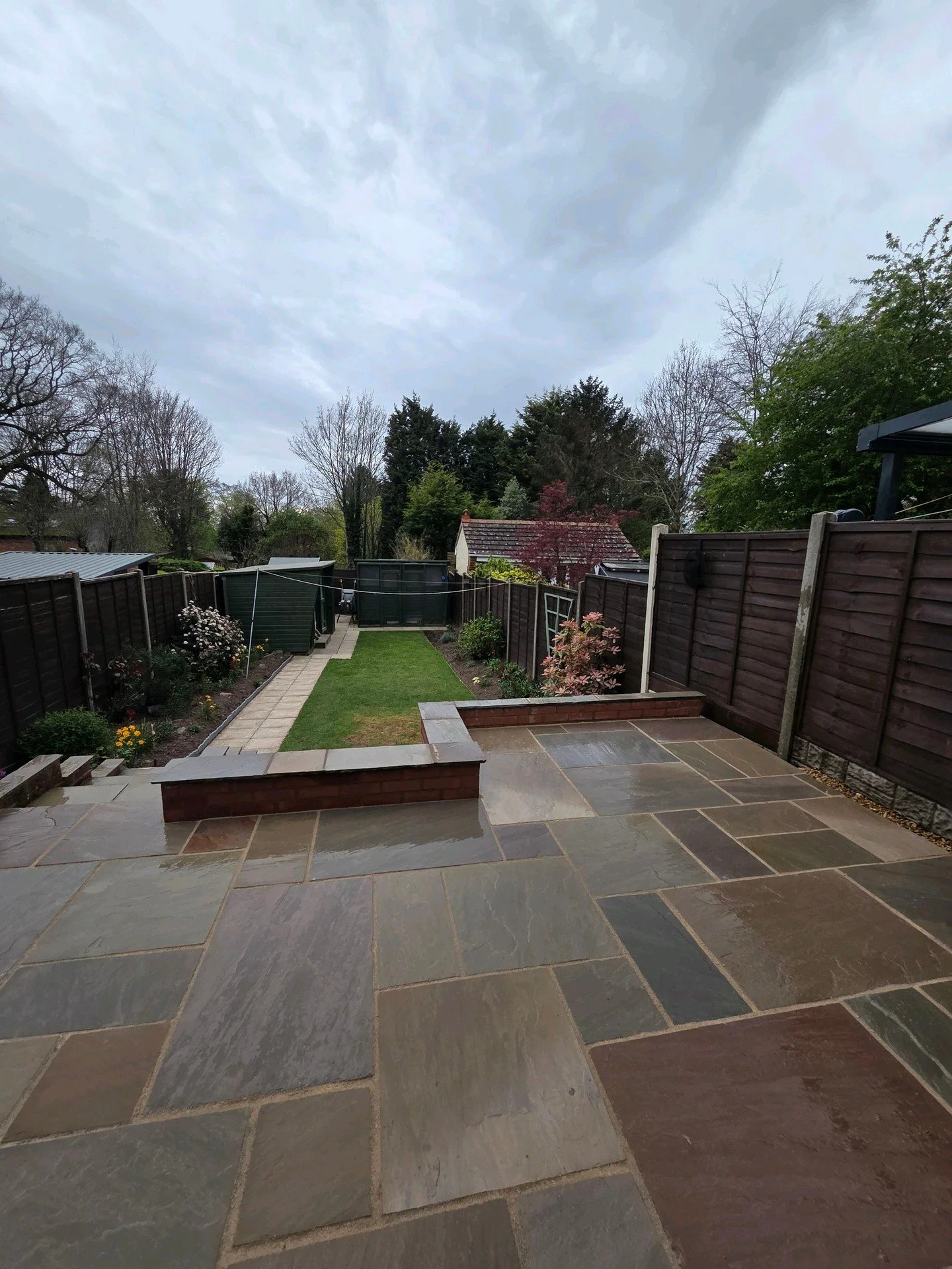 A small patio completed last week using Raj Blend Indian sandstone and finished with Mushroom Easygrout. 

We rebuilt sections of the brick retaining wall whilst extending on the old patio, replaced the old concrete pavers for the natural stone and f